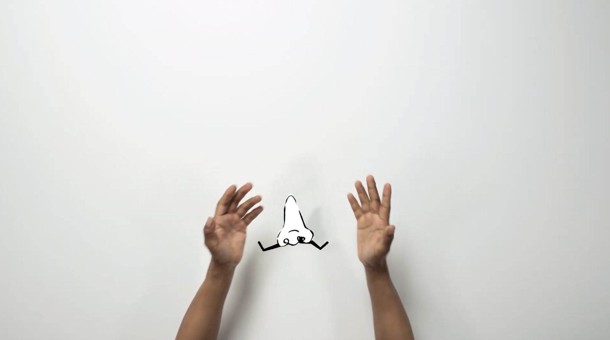 Two hands on a white background with an animated nose in the middle