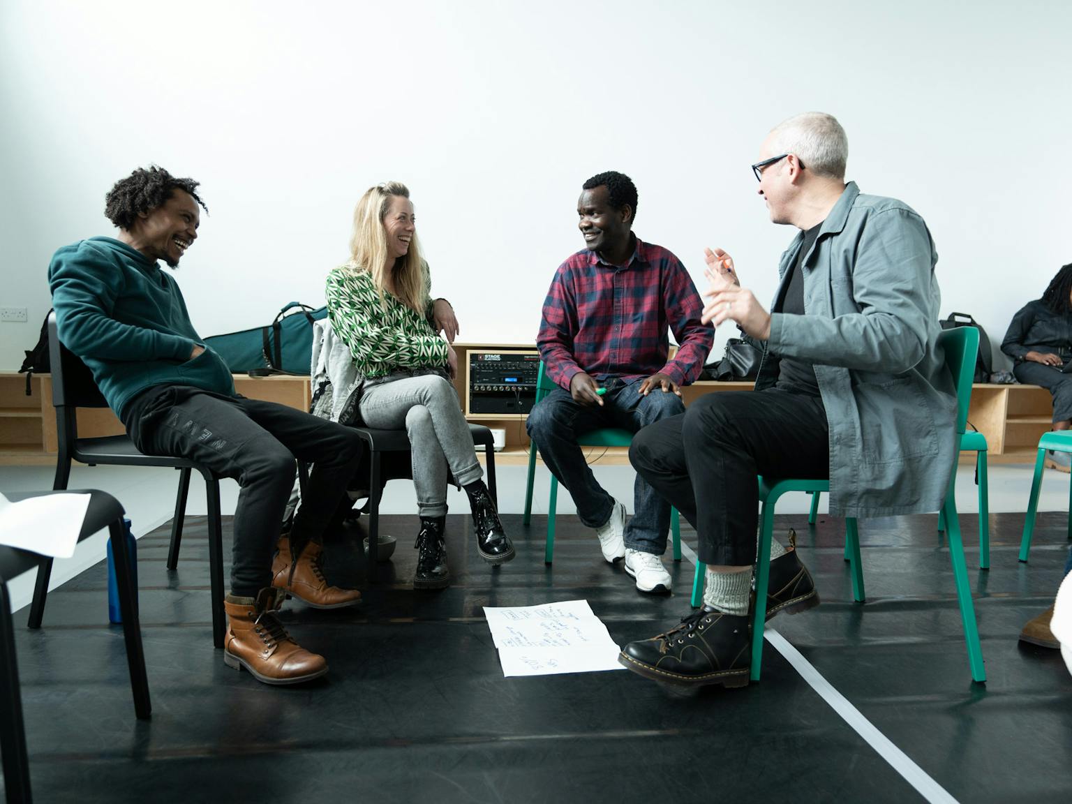 A group of people sat in a circle laughing