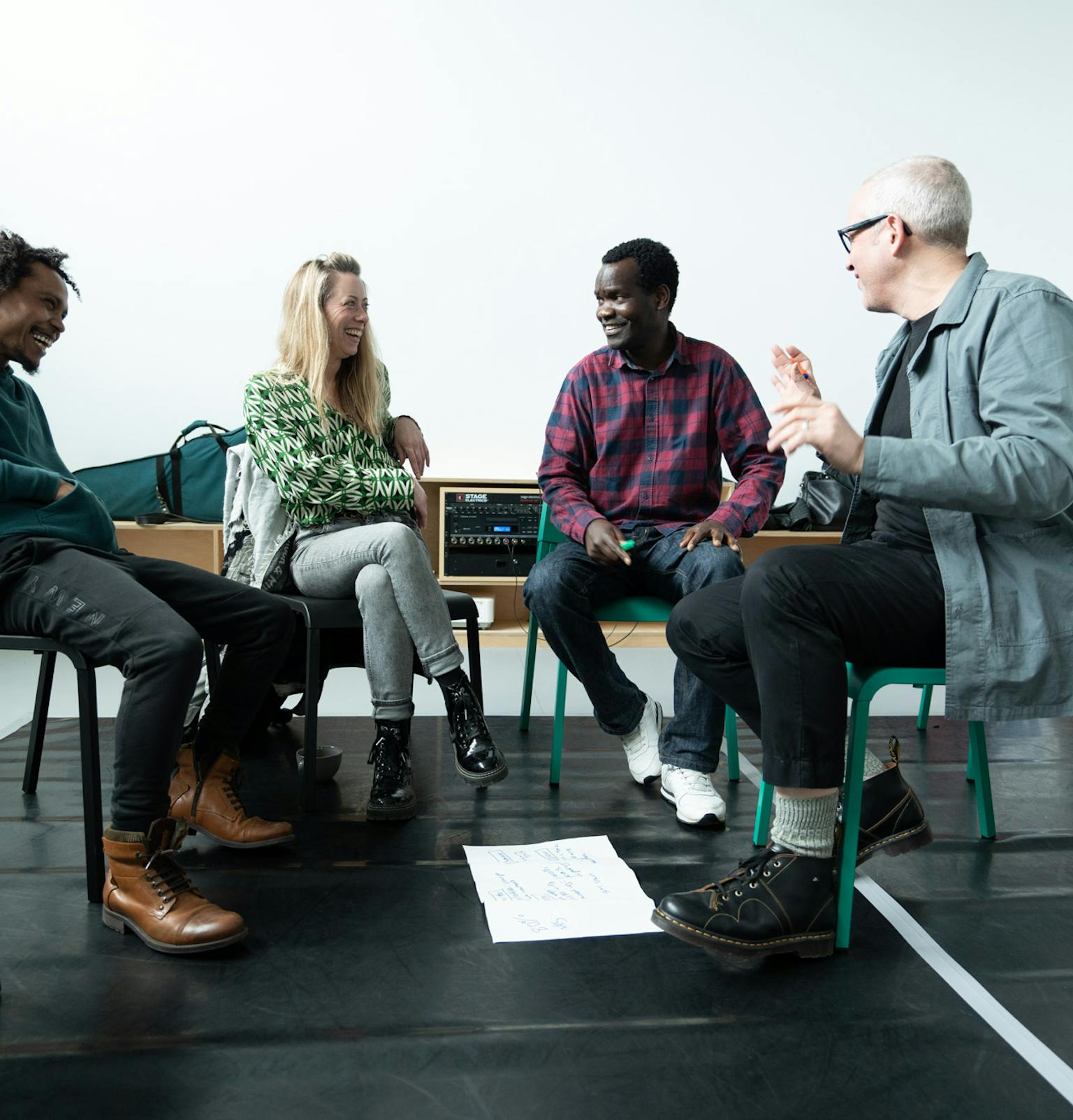 A group of people sat in a circle laughing