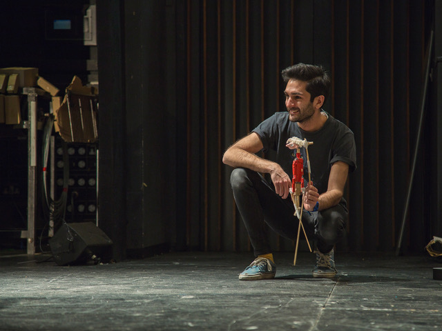 An artist looking to the side and smiling 