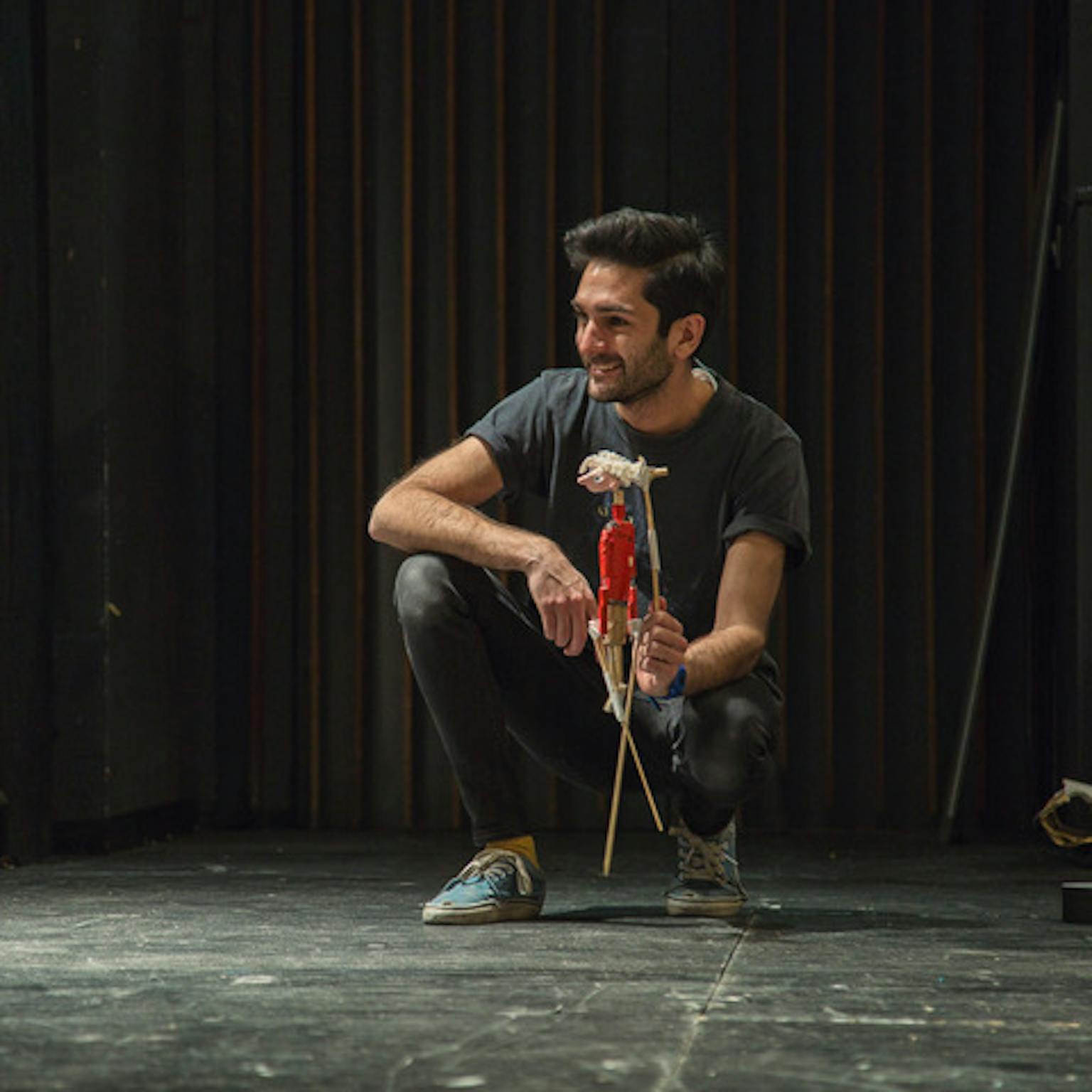 An artist looking to the side and smiling