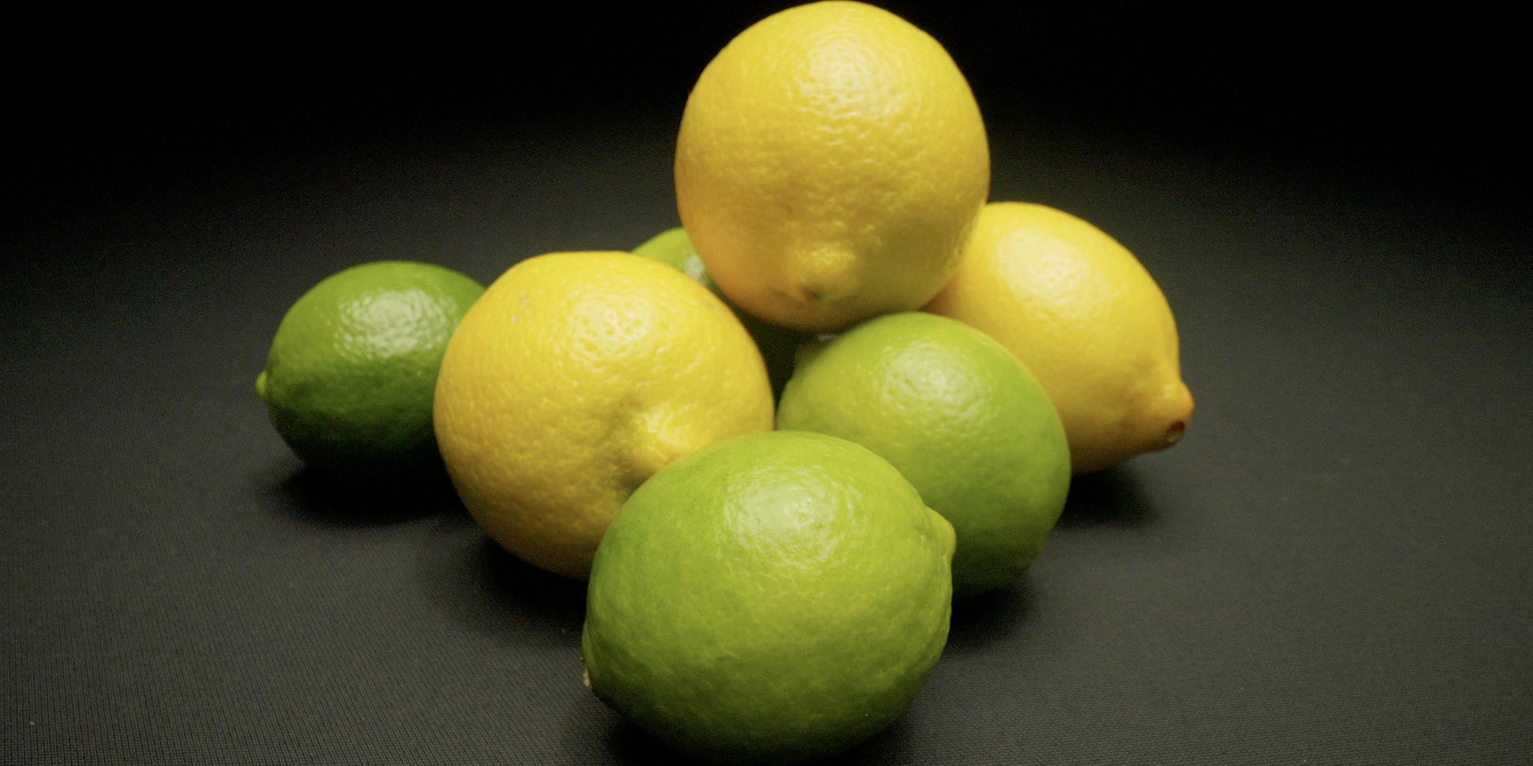 A selection of lemons and limes in a darkly lit room