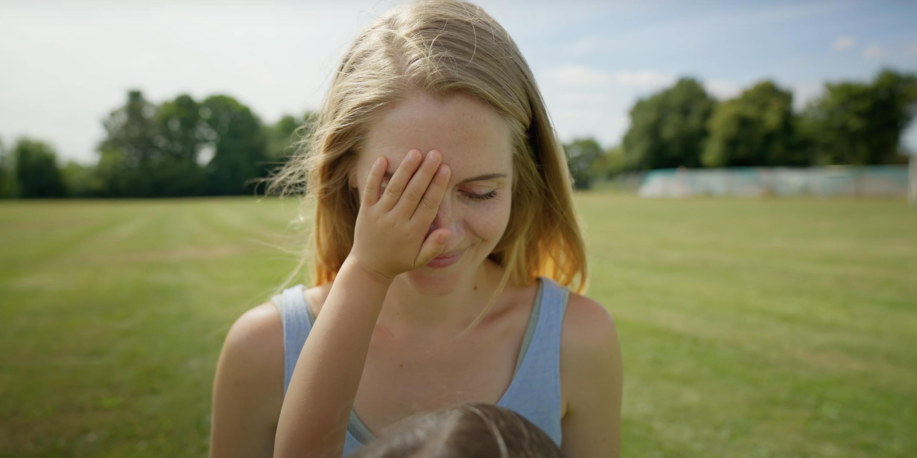 A child touching their parent's face