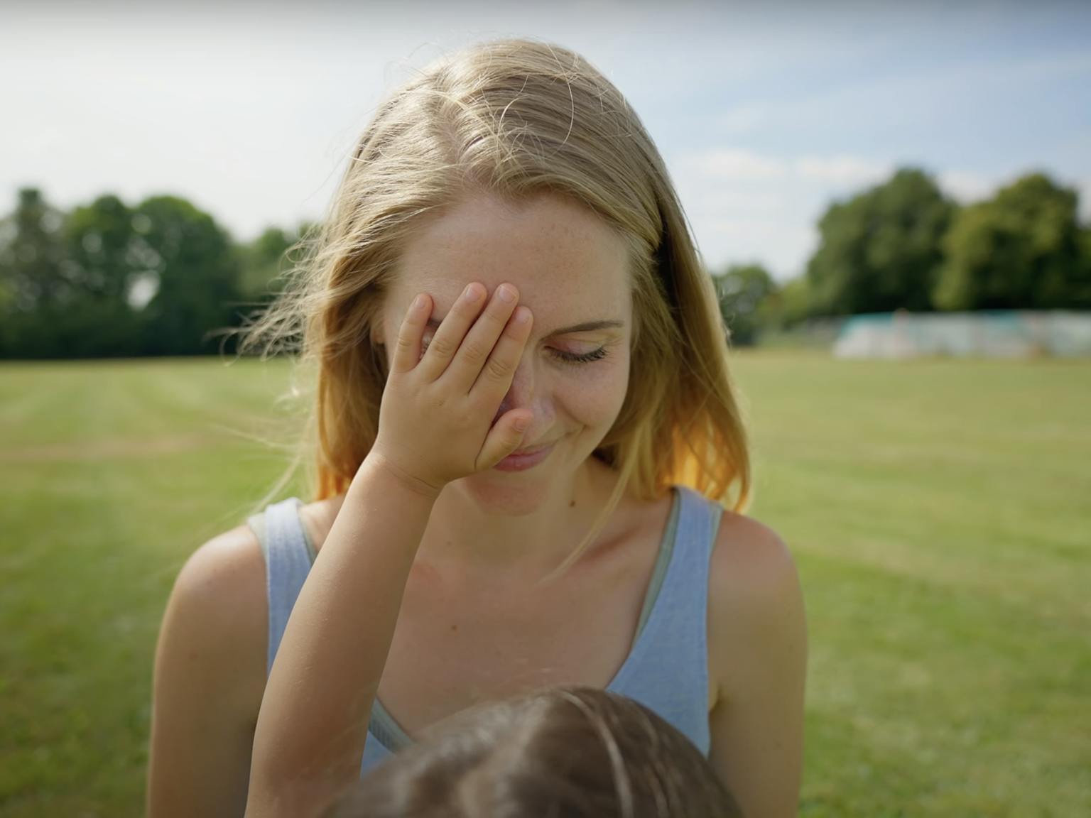 A child touching their parent's face