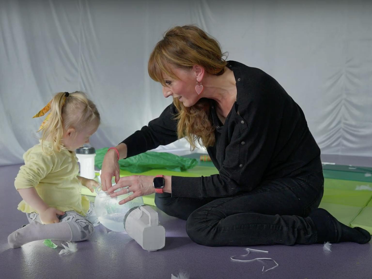 An artist and young young are exploring light during a session