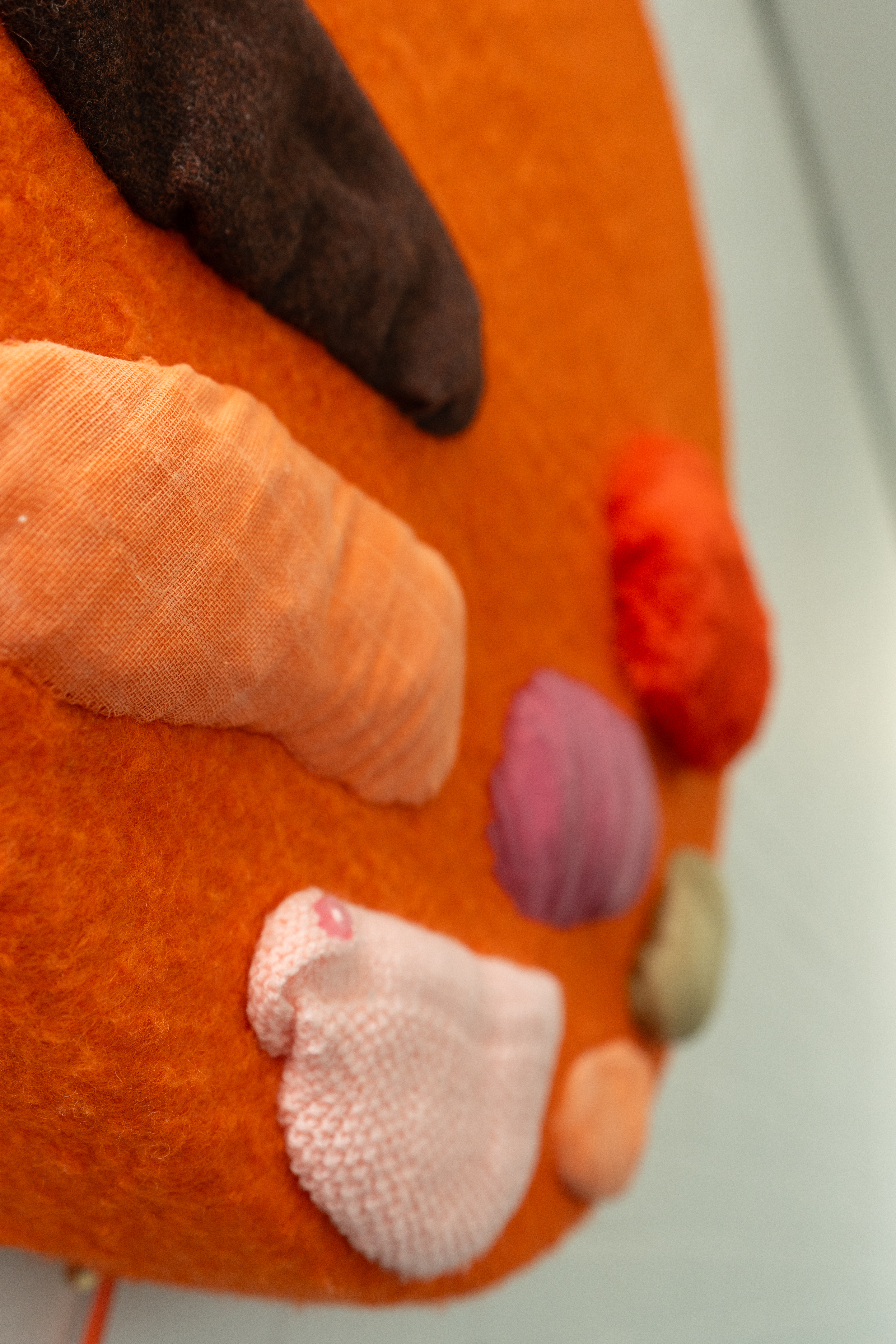 A close up of the Infant Feeding artwork shows a textured orange circle with different coloured shapes and textures added to it.