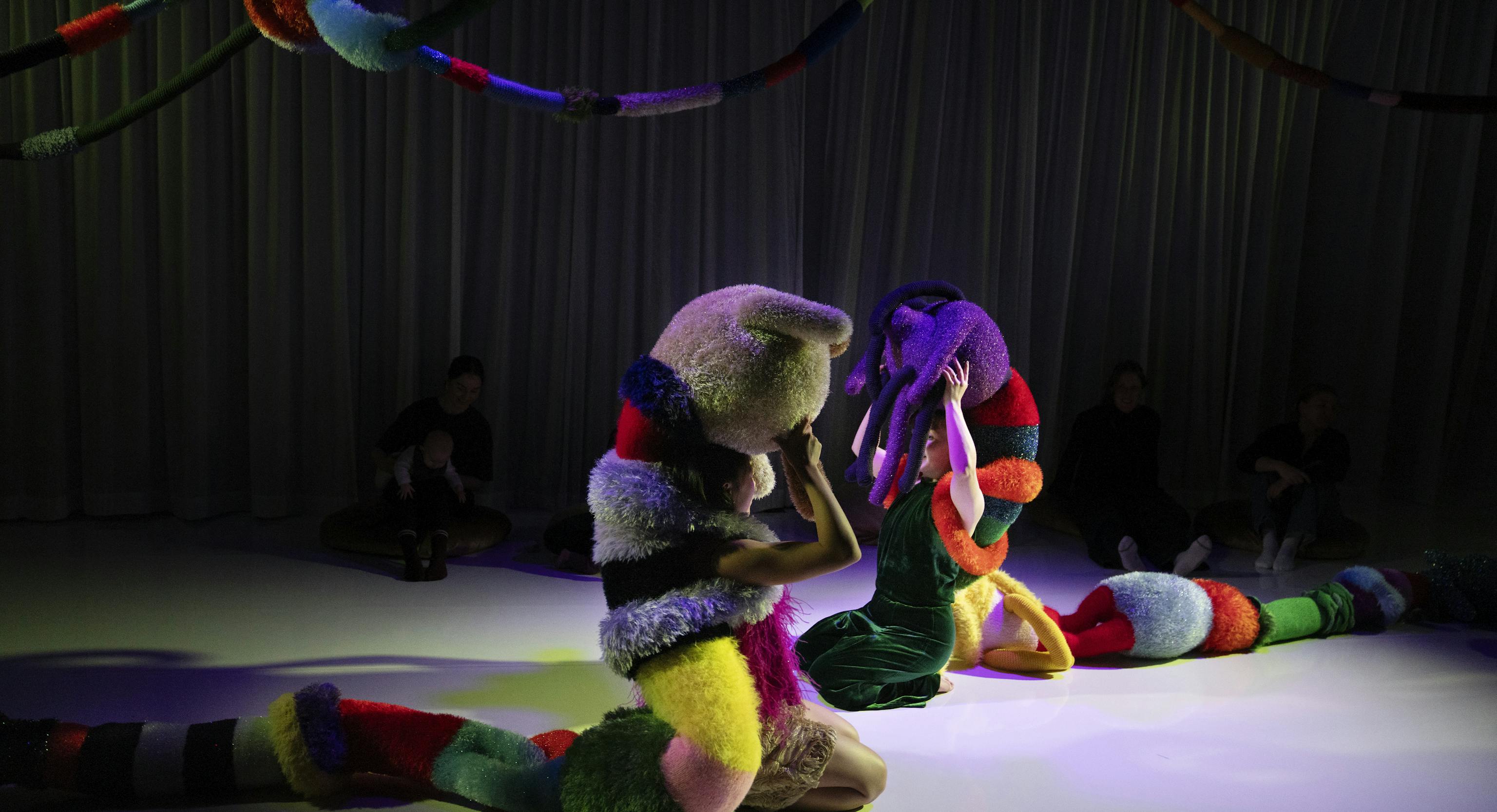 Two textured shapes on stage with a spotlight over them