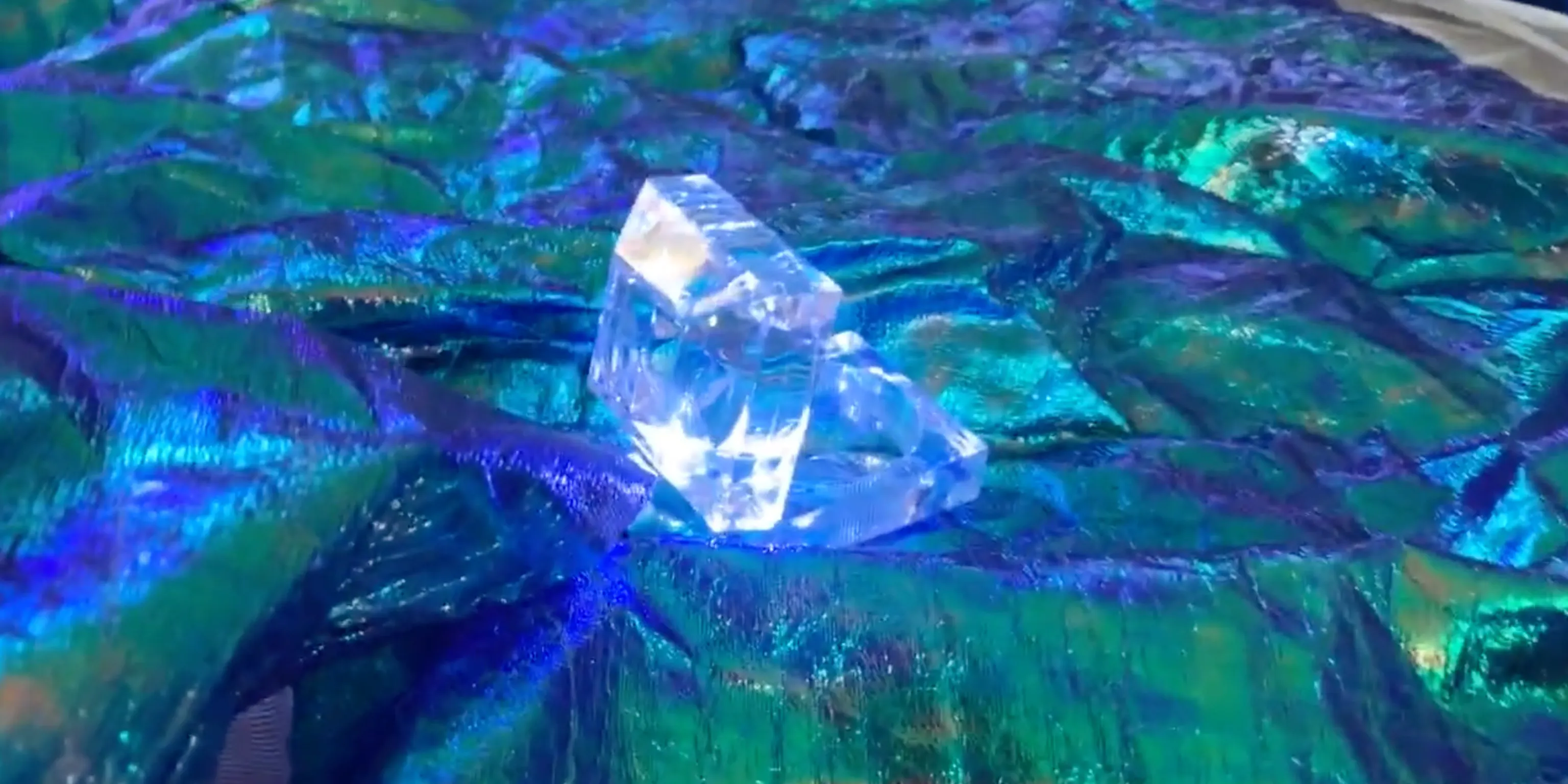 A light shines brightly surrounded by blue/green materials