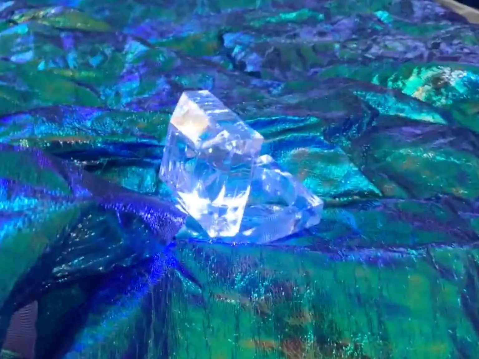 A light shines brightly surrounded by blue/green materials