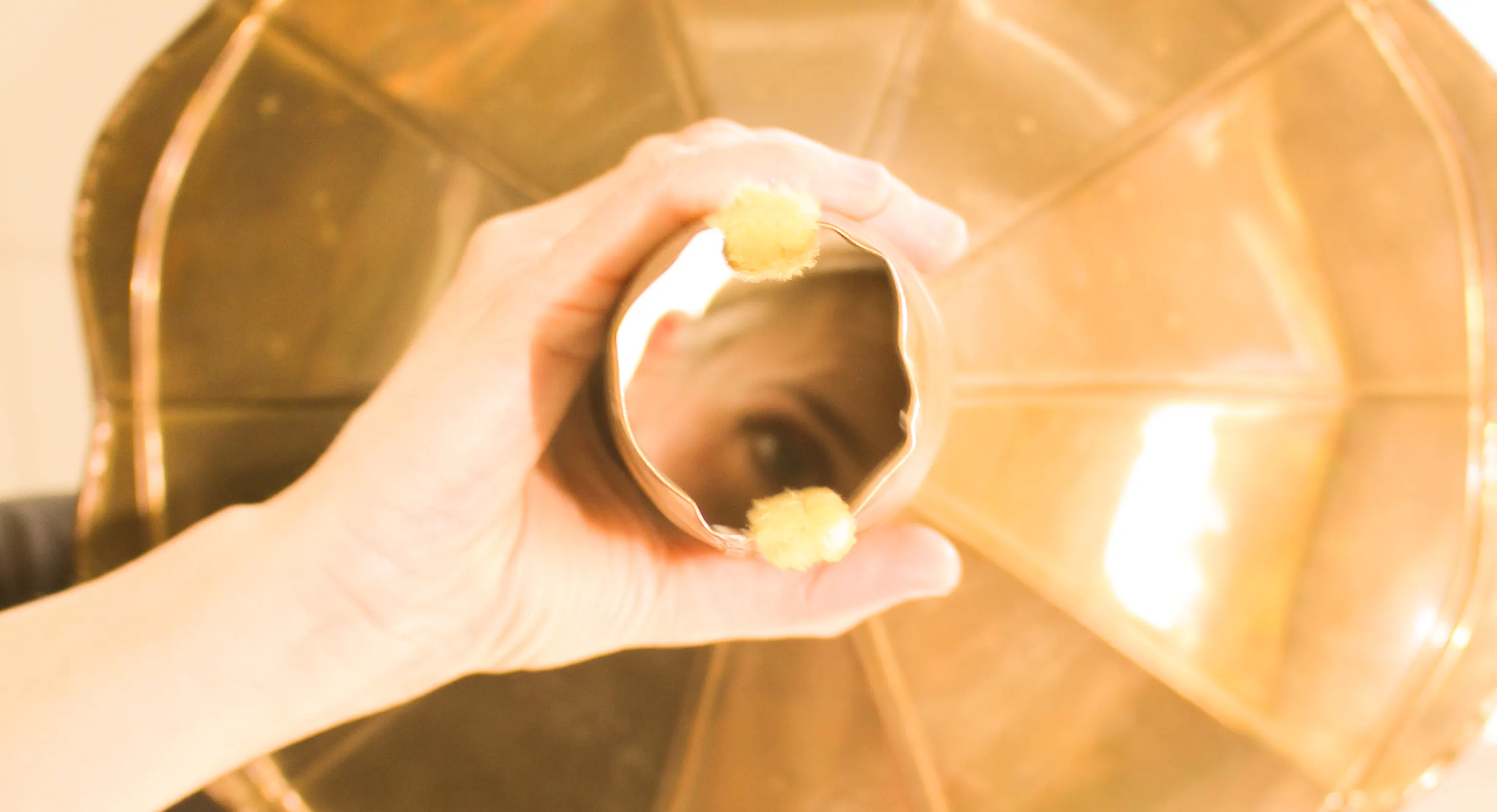 A performer is looking through a hole from an instrument