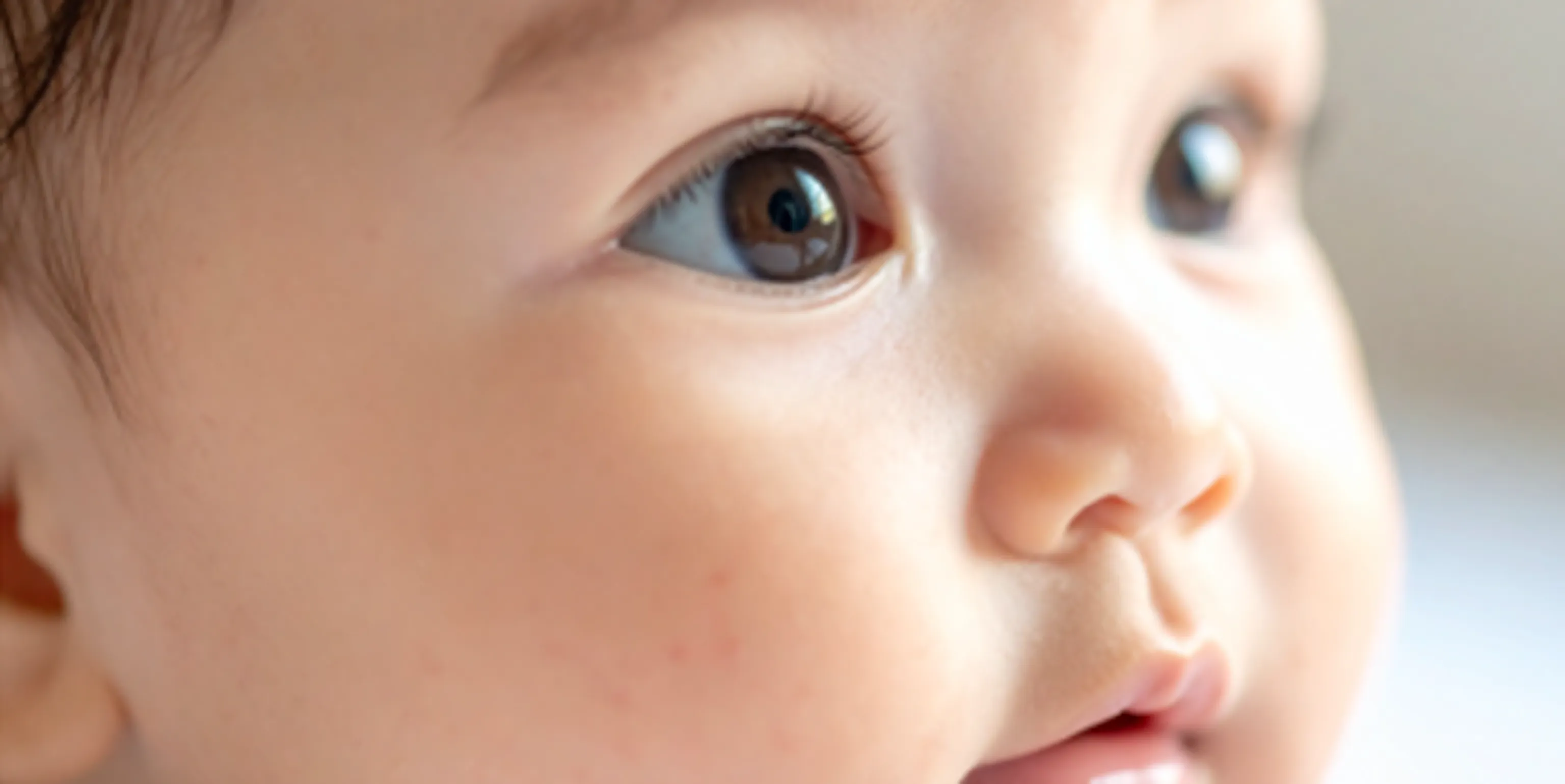 Two babies looking up