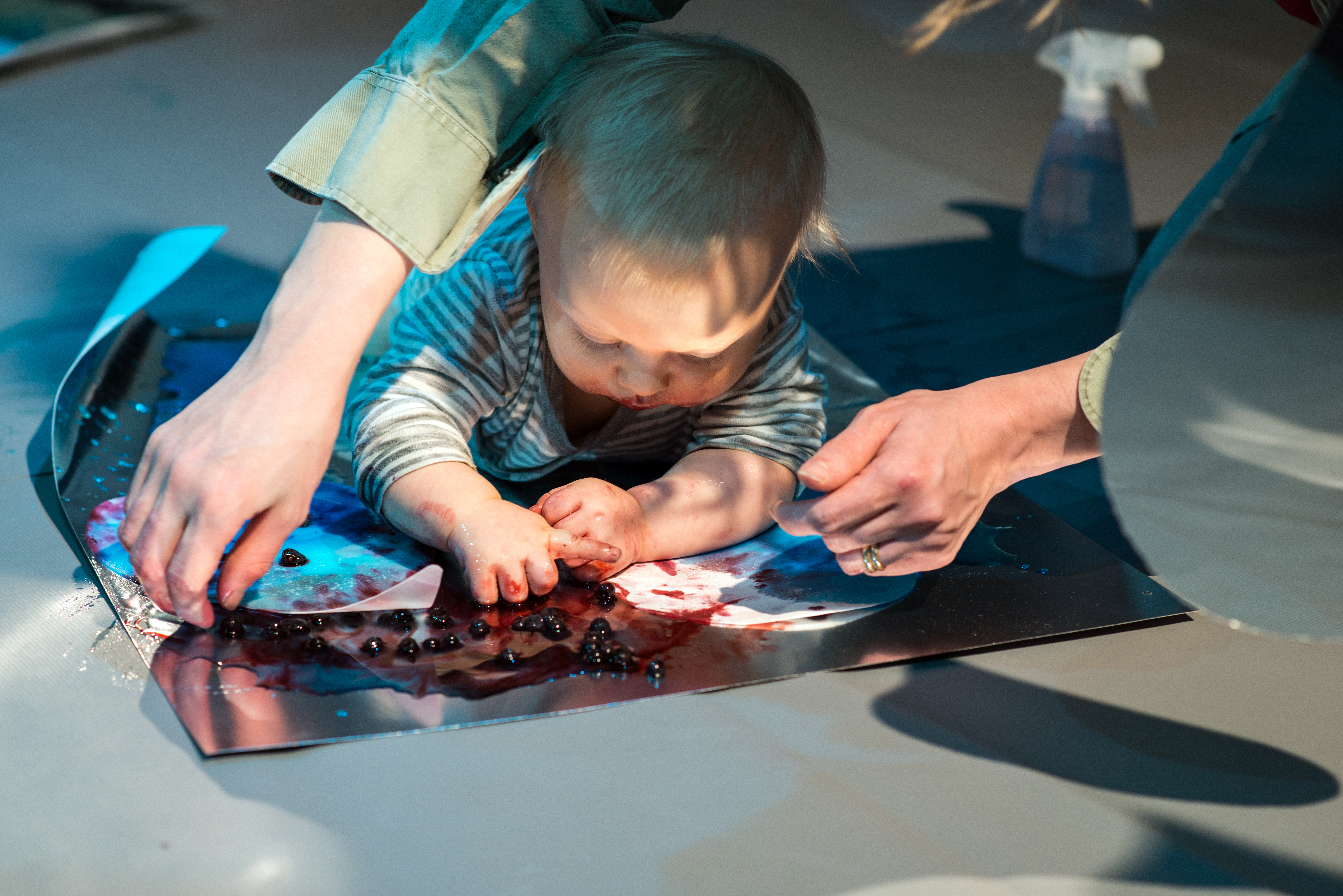Colour Workshops: a baby lying on their front and engaging with colours
