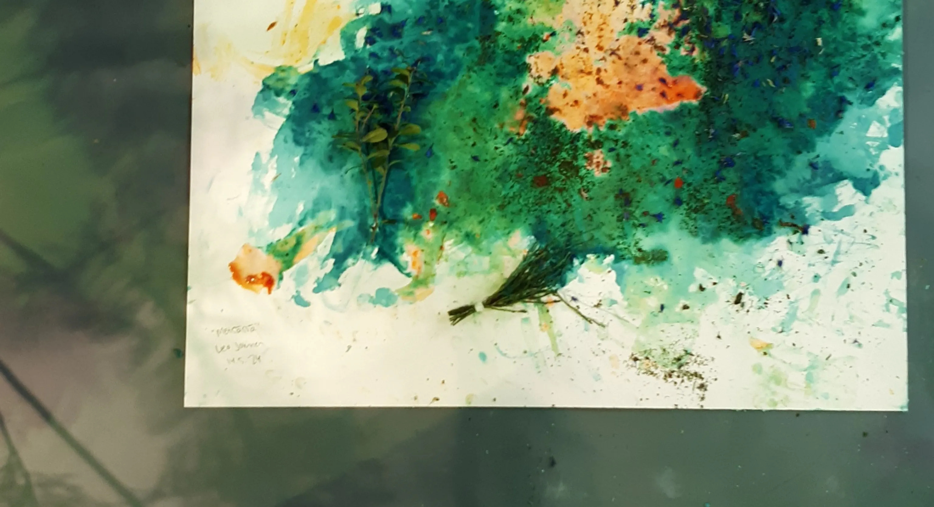 A painting using fruit and natural colourings. The main colours are green, blue and yellow