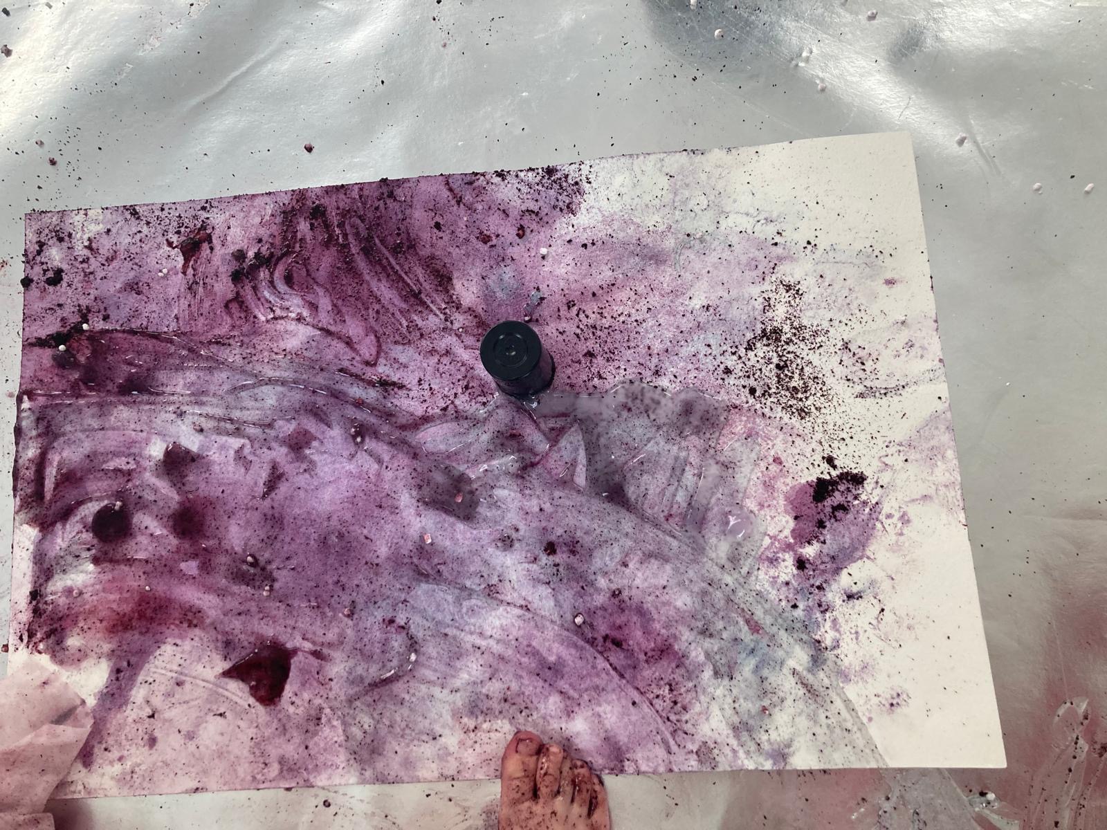 A blue and purple abstract painting created using blended food materials lemon and blueberry.