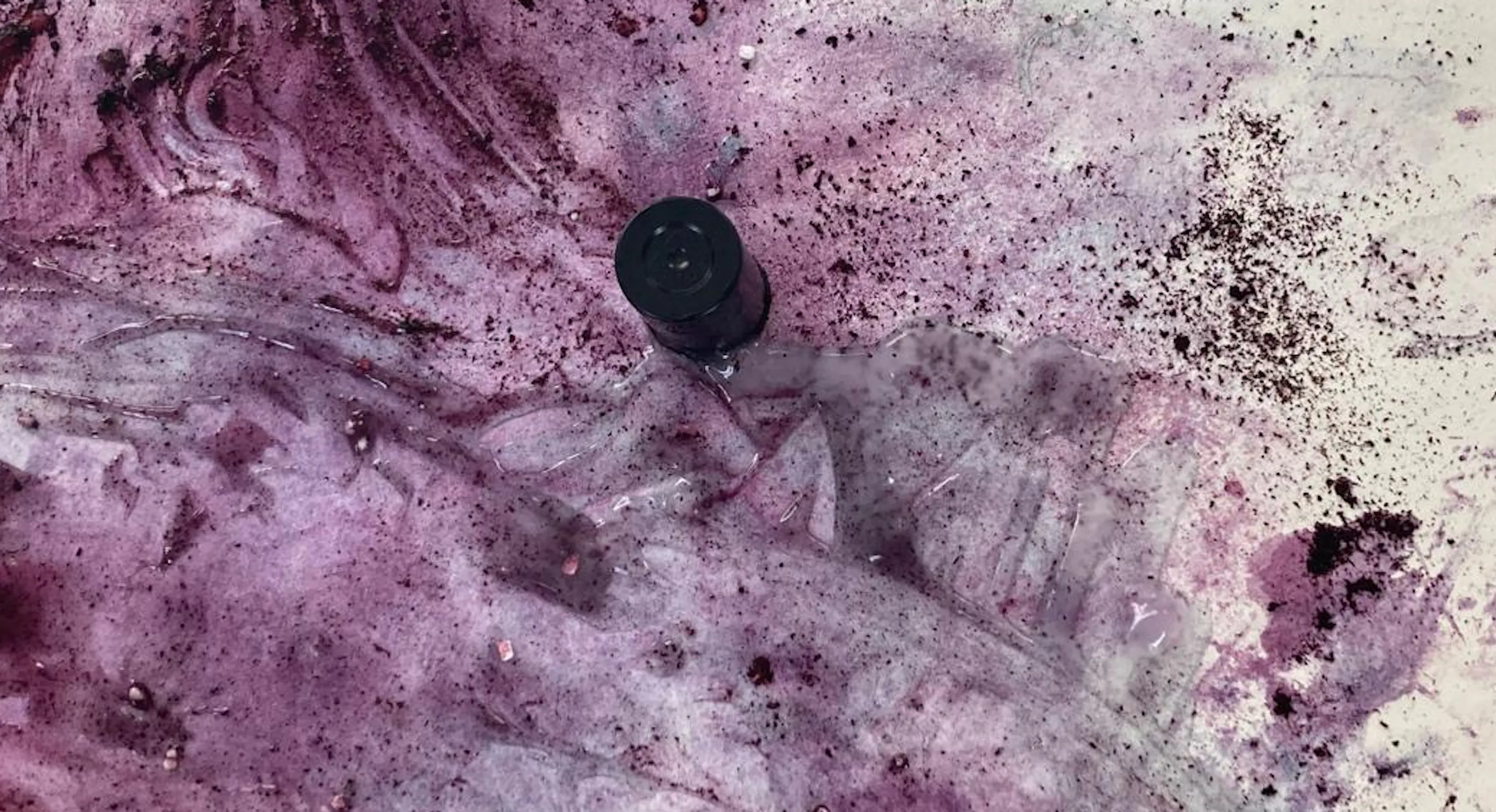 A blue and purple abstract painting created using blended food materials lemon and blueberry.