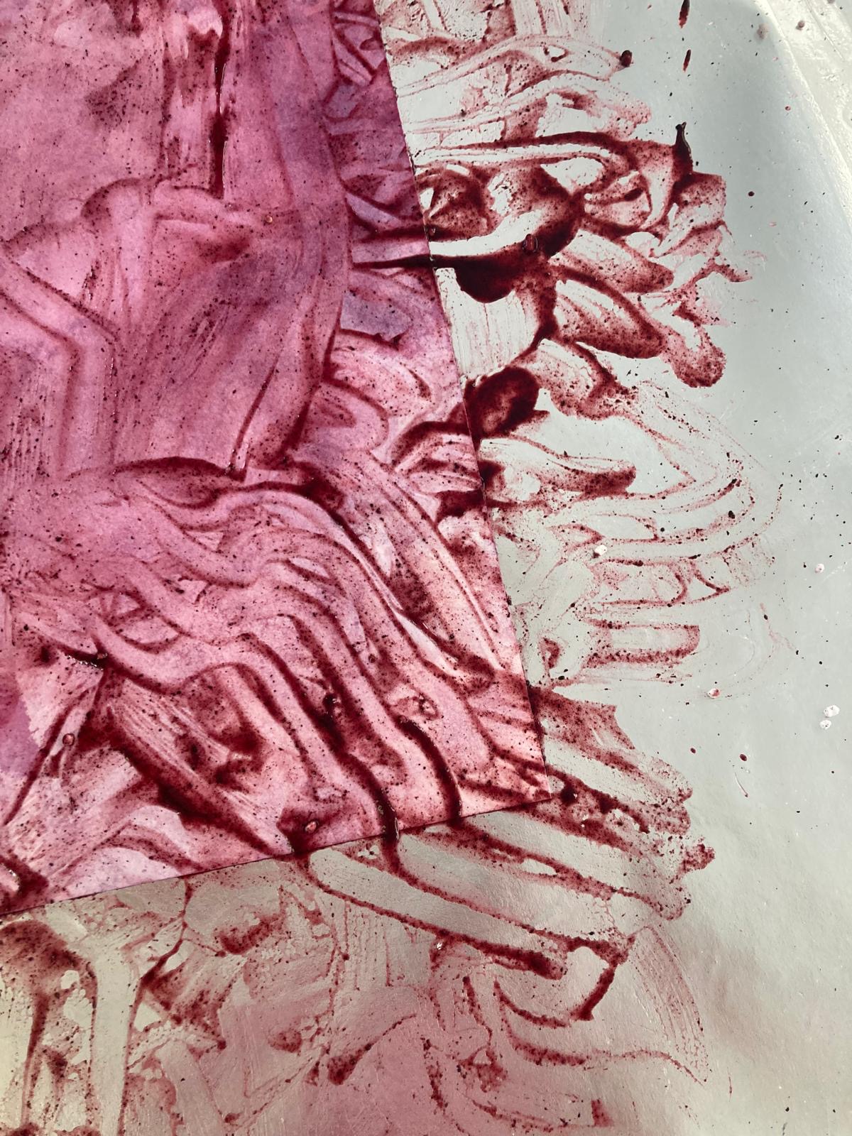 A pink and purple abstract painting created using blended food materials lemon and blueberry.