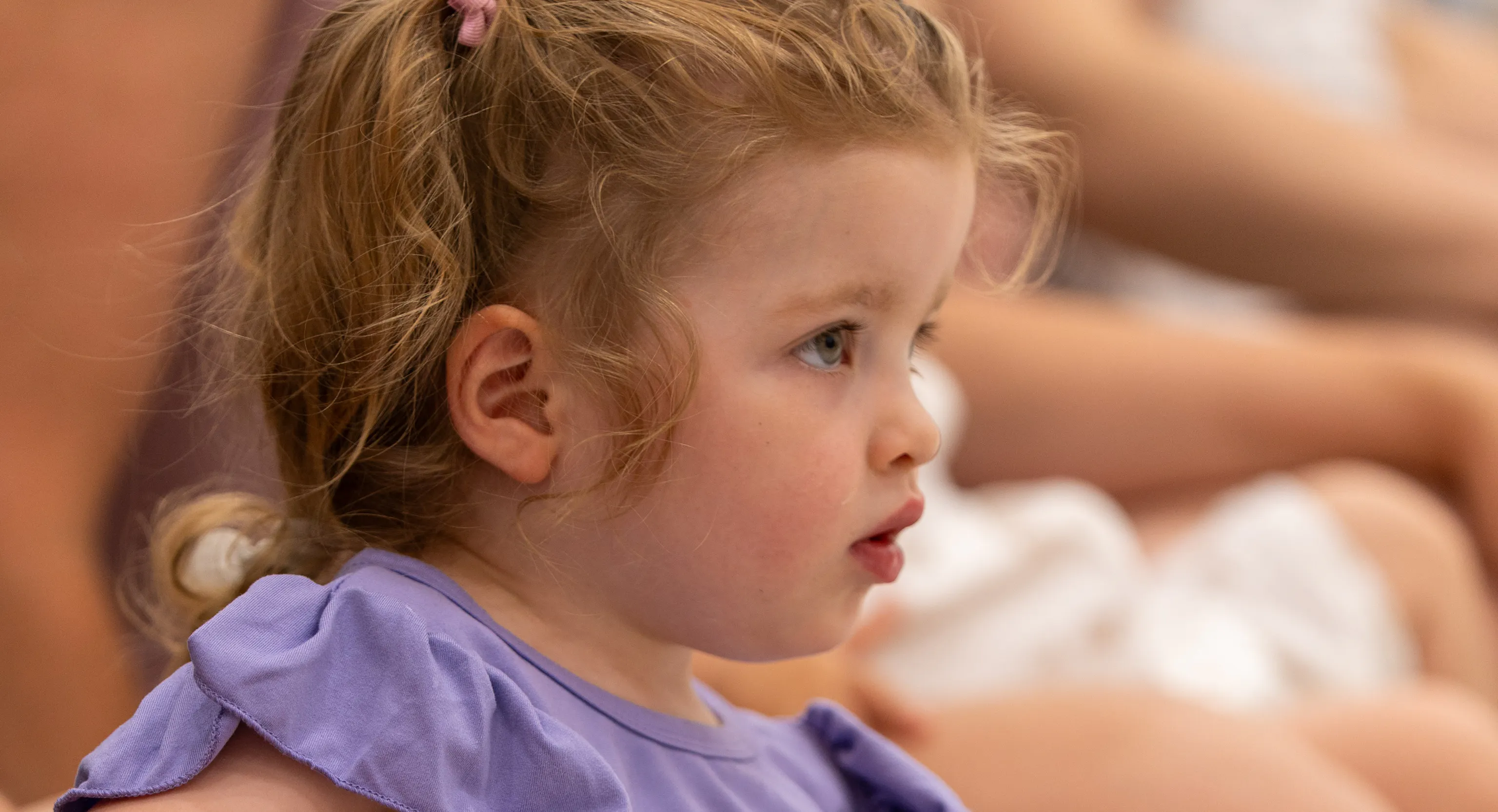 A young child looking at a performance