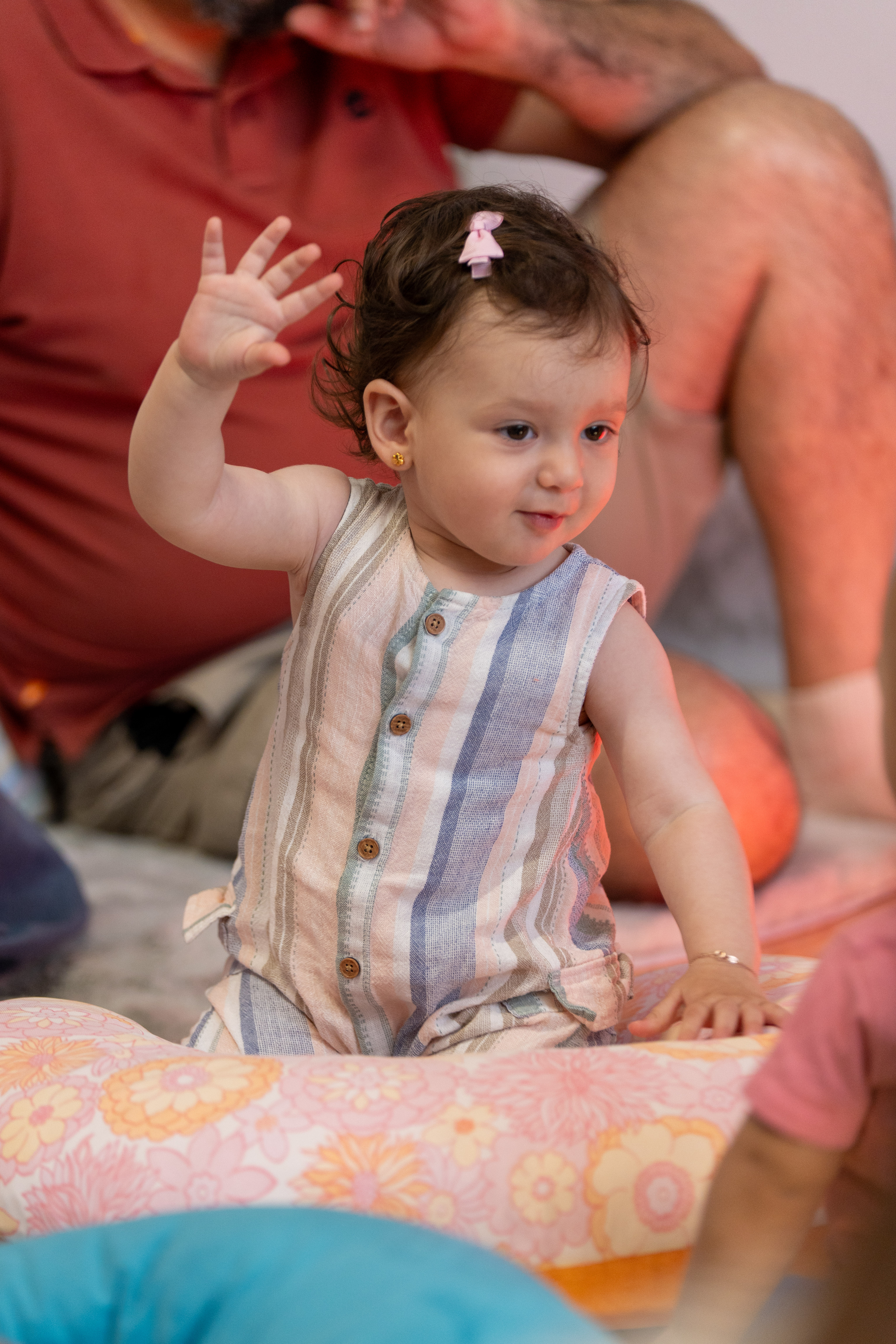 A baby waving during a performance 
