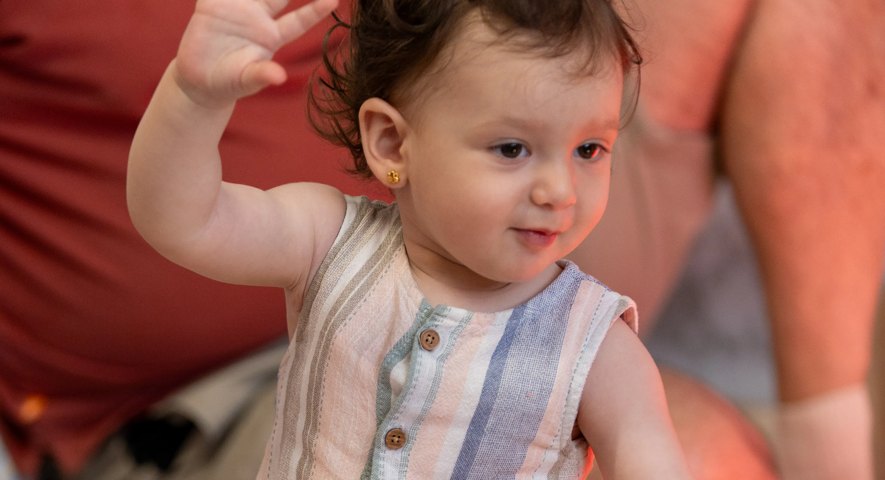 A baby waving during a performance