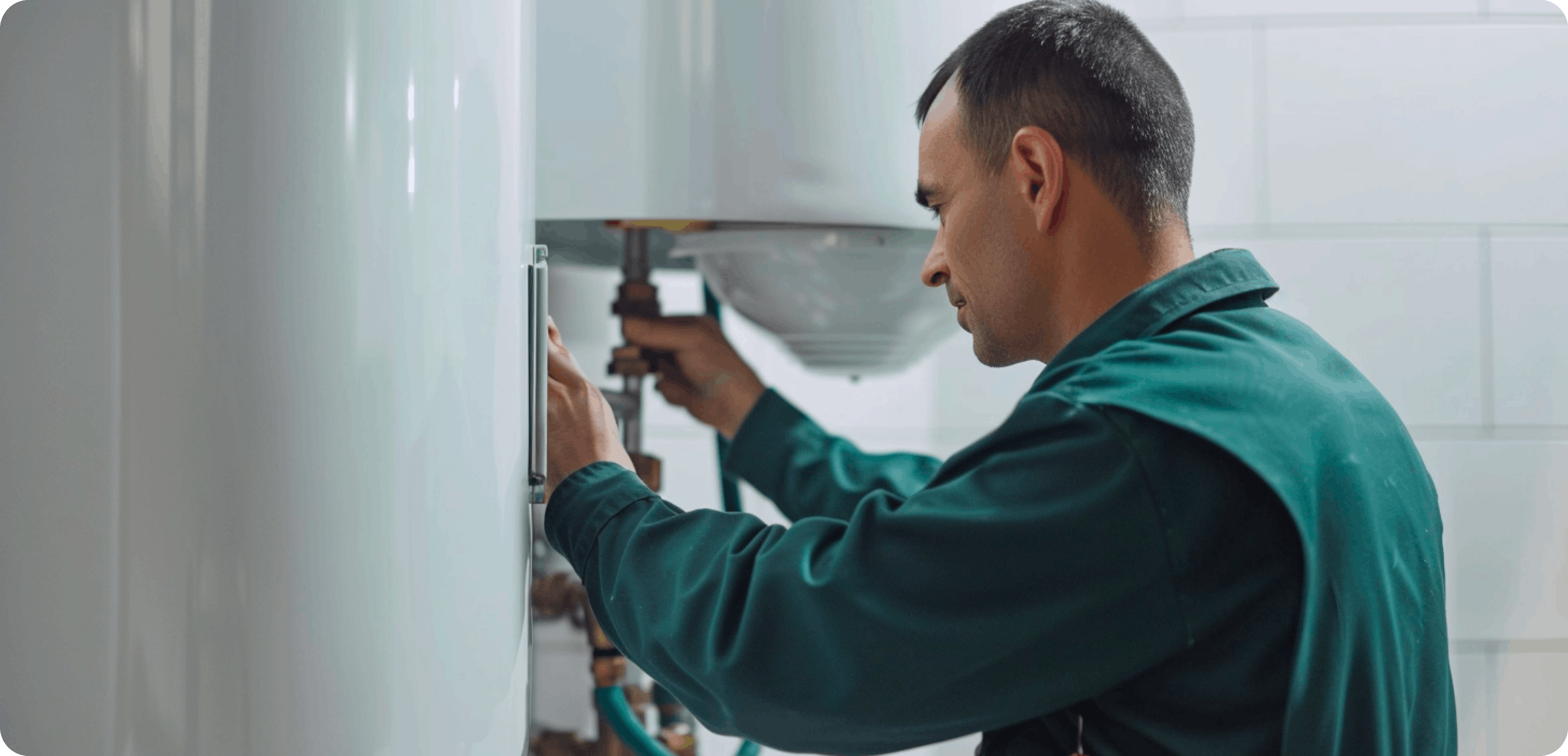 A plumbers fixes a boiler