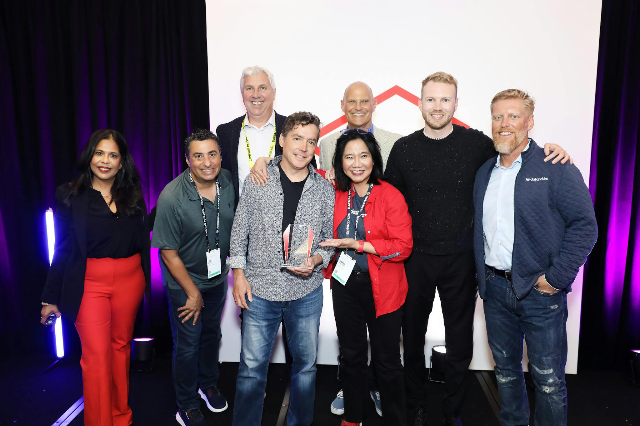 Plotly Jim McIntosh (CEO), Chris Parmer (CPO and Co-founder of Dash), and Dave Gibbon (Sr. Director - Strategic Partnerships) accepting the Databricks Customer Impact Partner of the Year award.