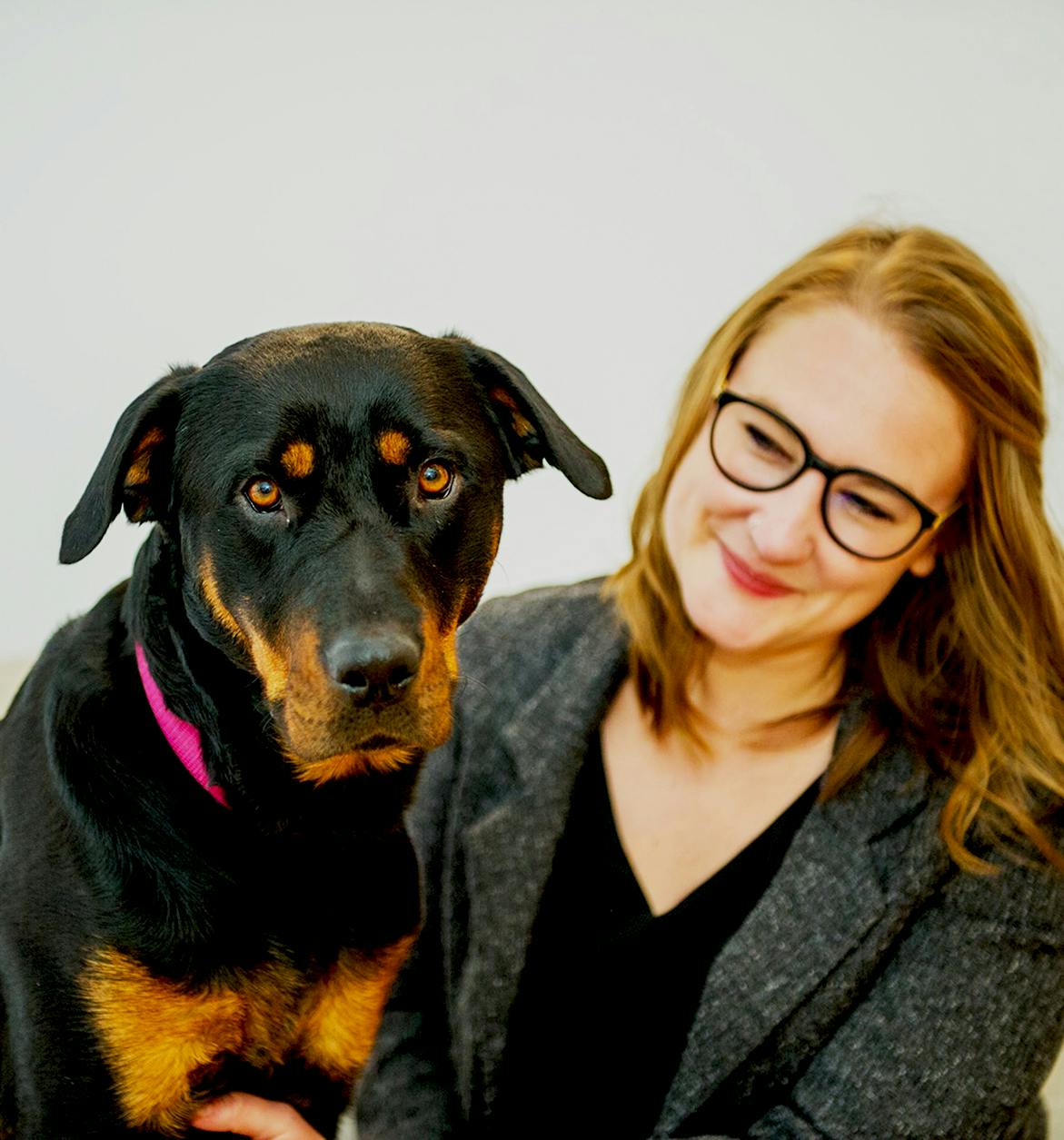 girl smiling with dog at plotly office
