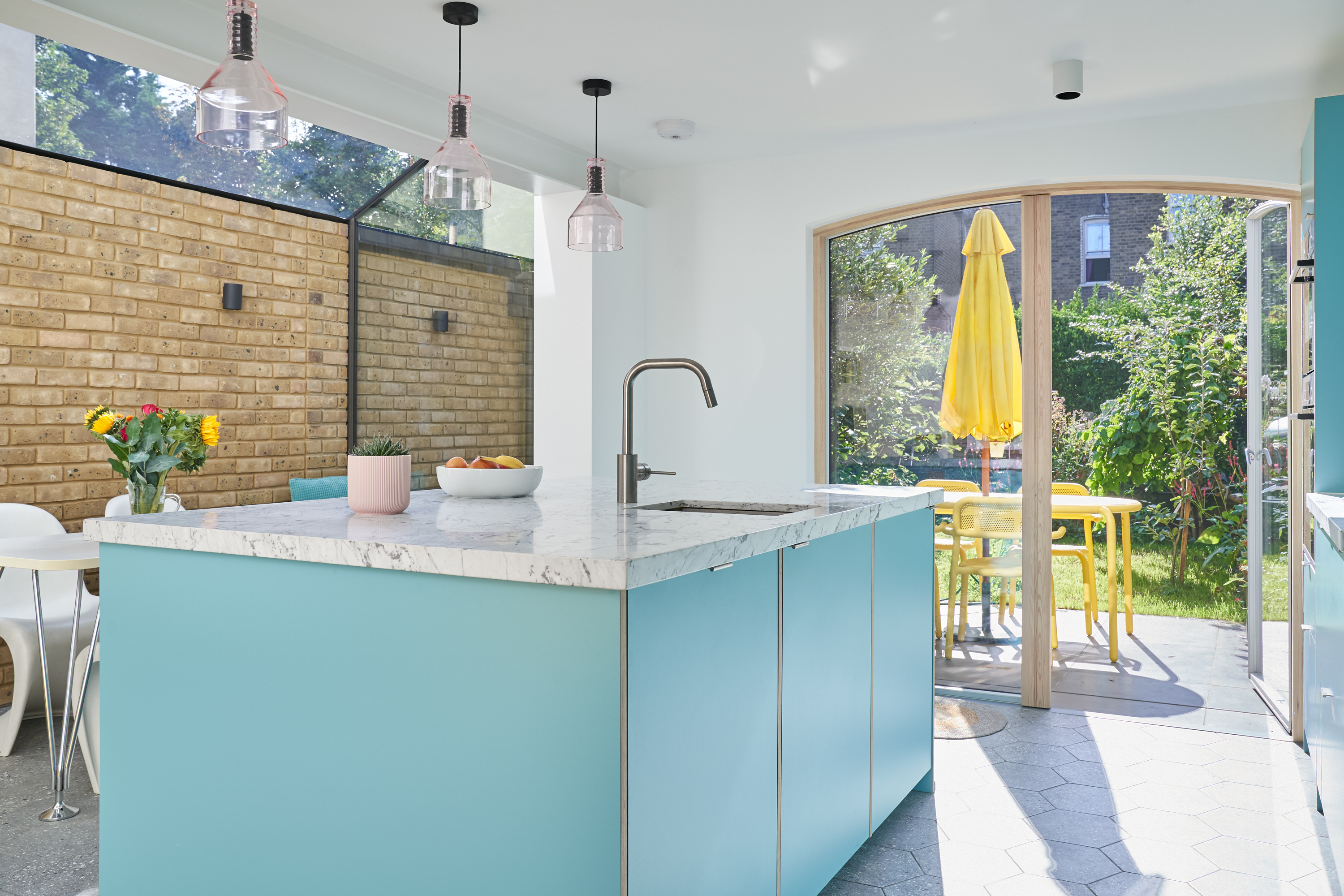 Plykea Formica Maui fronts with nickel edge pull handles and birch ply spacers on the island