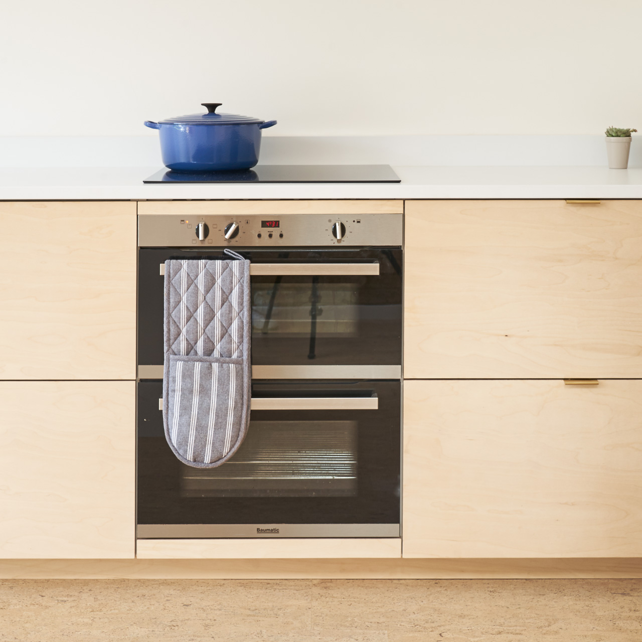 Birch plywood fronts and brass edge pulls handles in our Greville Road kitchen