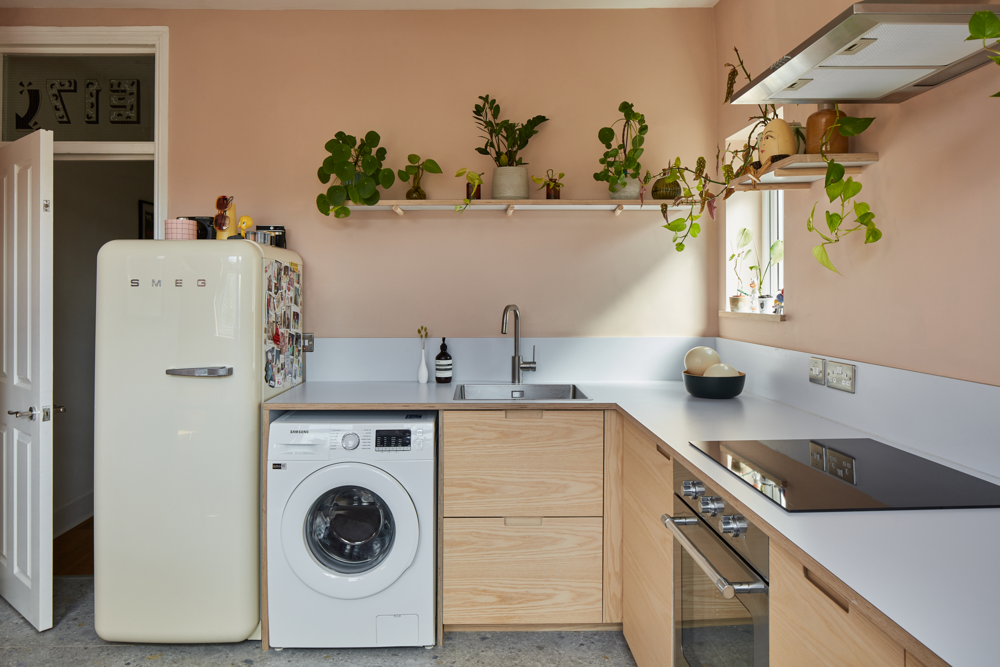 Plykea ash plywood fronts with semi-recessed handles and a Formica Glacier worktop and upstand