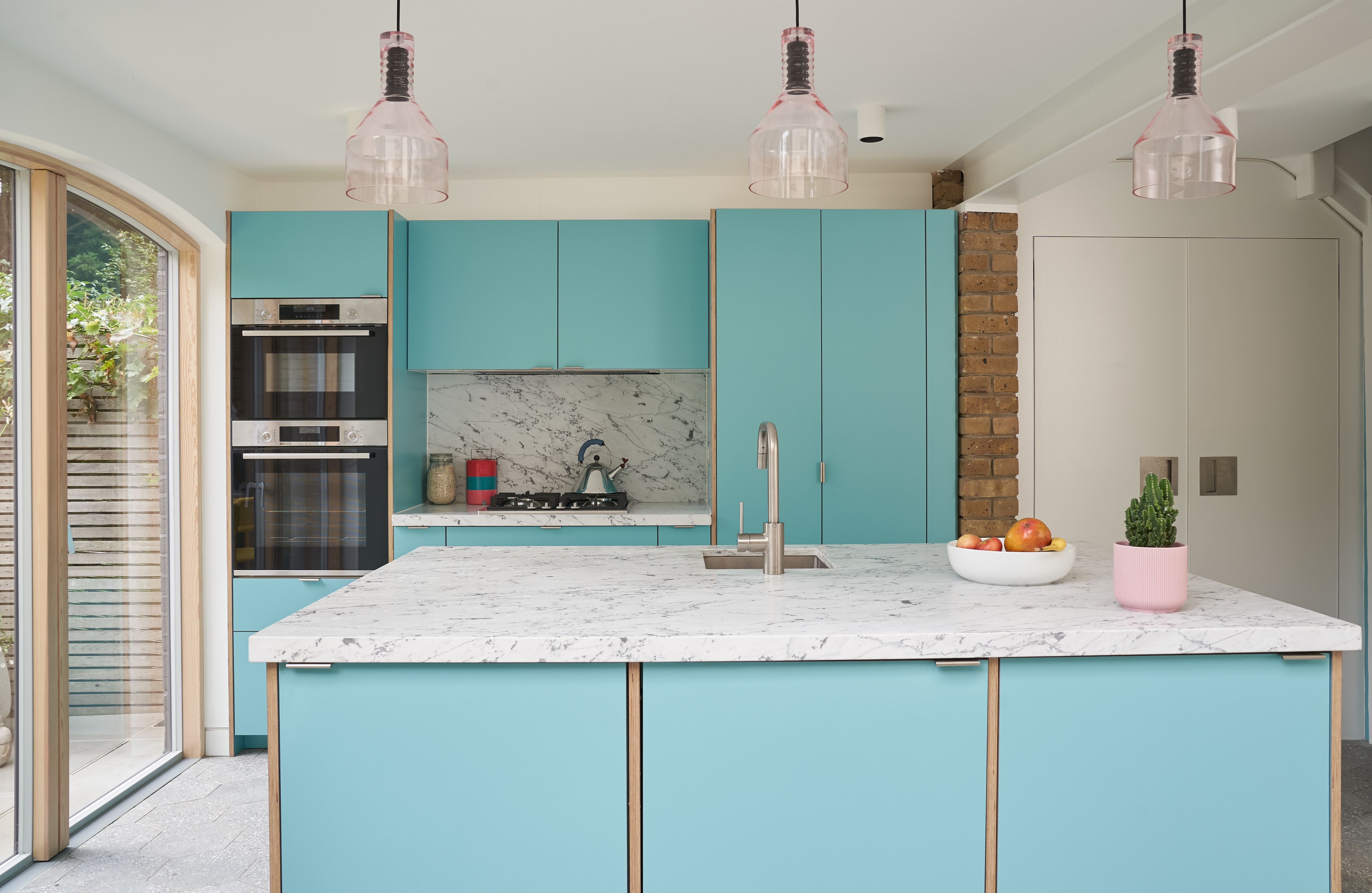 Plykea Formica Maui fronts with nickel edge pull handles and birch ply spacers on the island