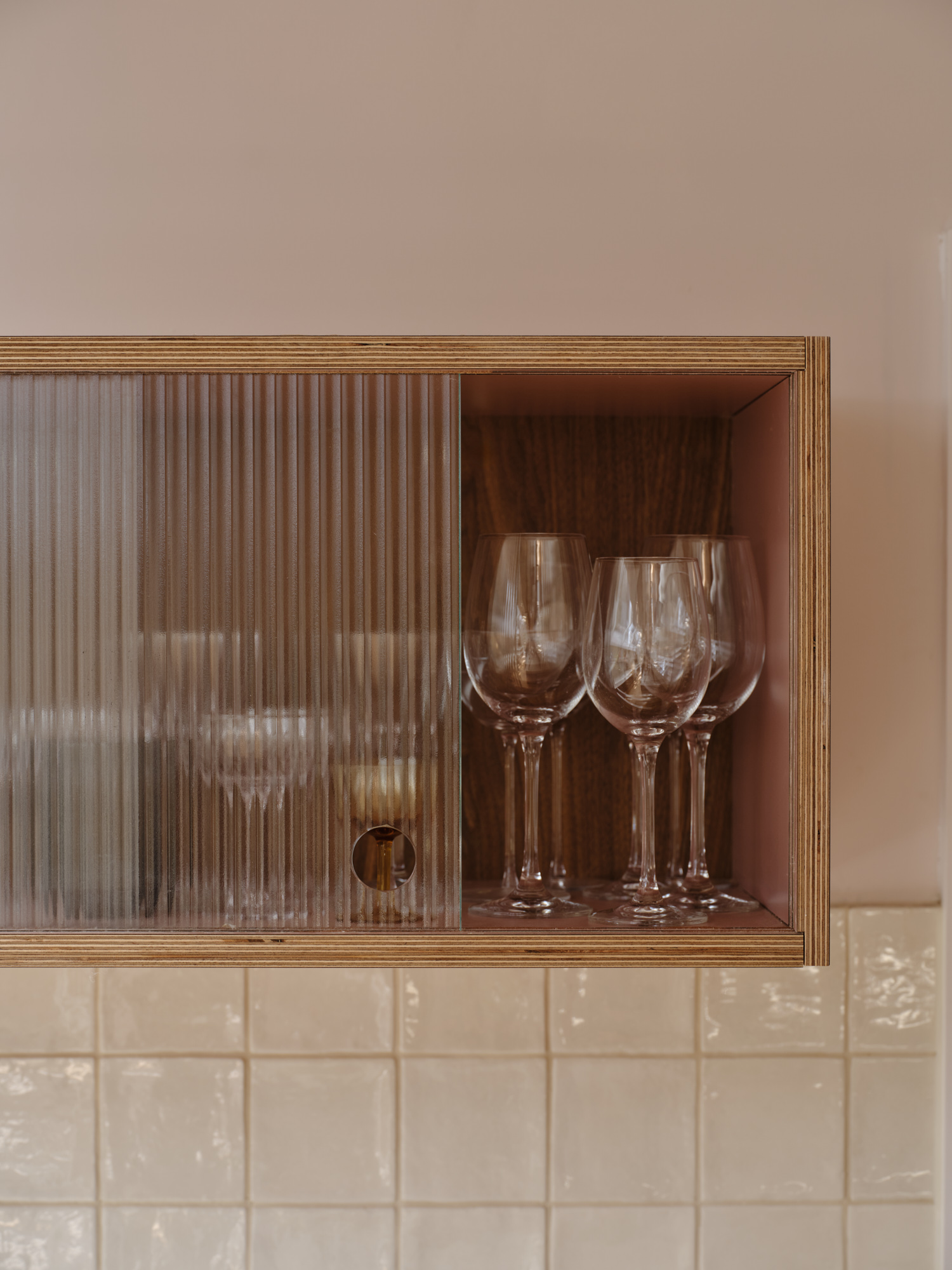 Plykea walnut veneered birch plywood wall unit with reeded glass doors