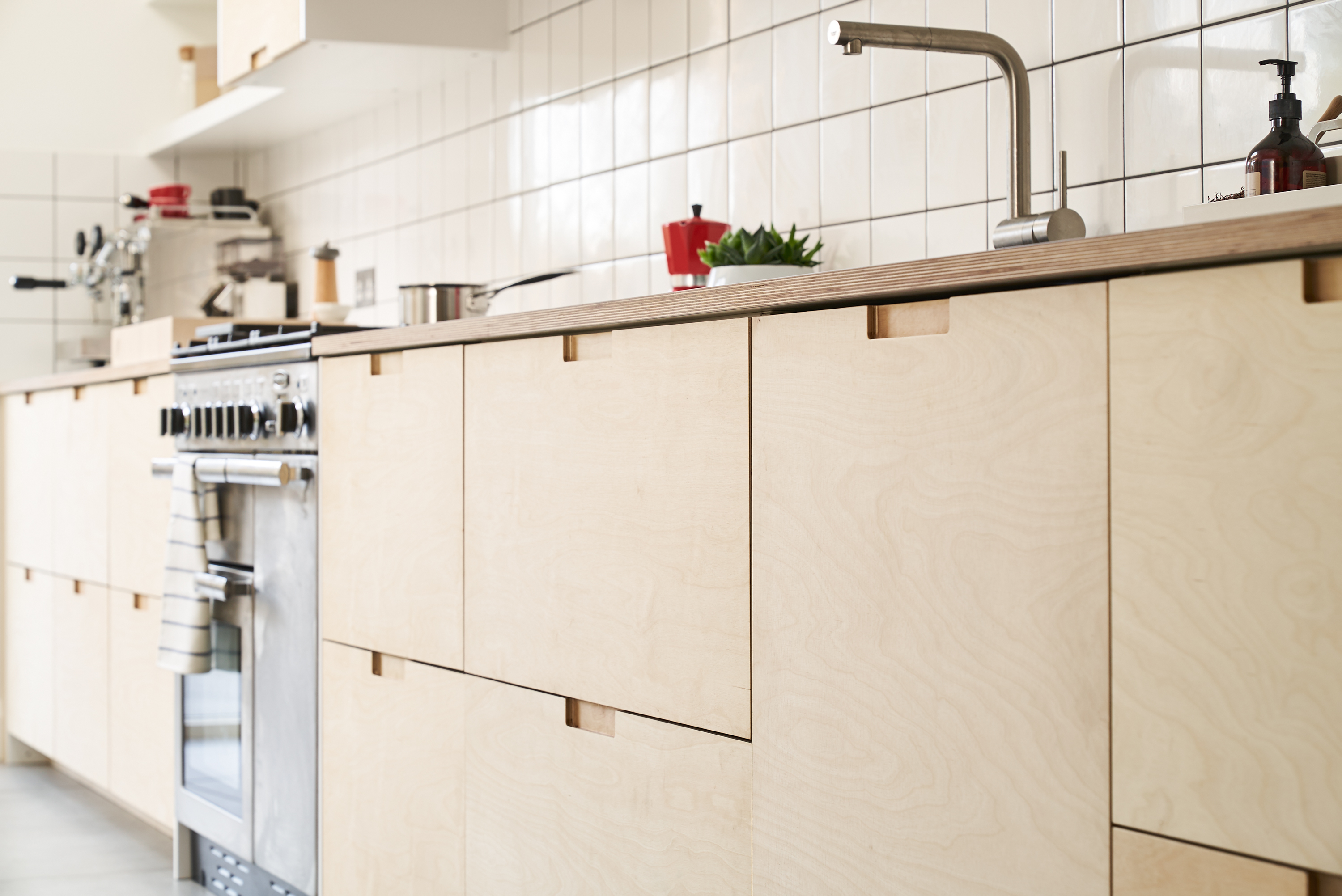 Birch plywood fronts, Formica countertops and semi-recessed grab handles