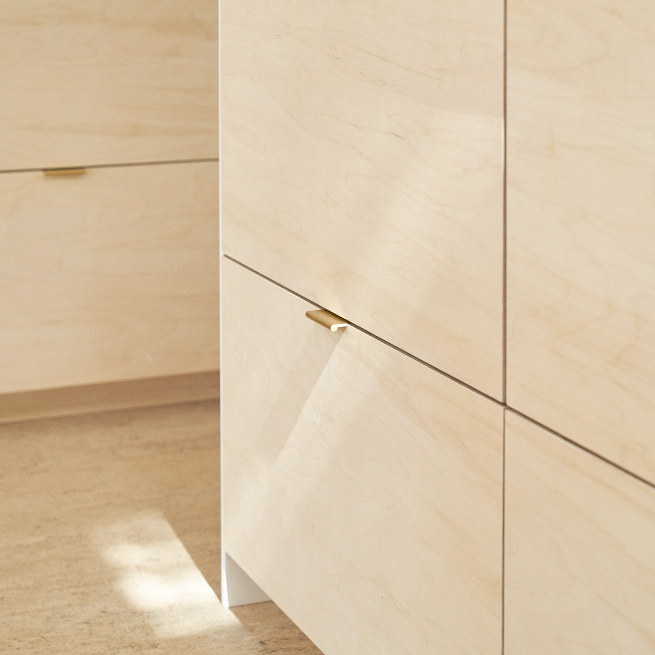 Birch plywood fronts and brass edge pulls handles in our Greville Road kitchen