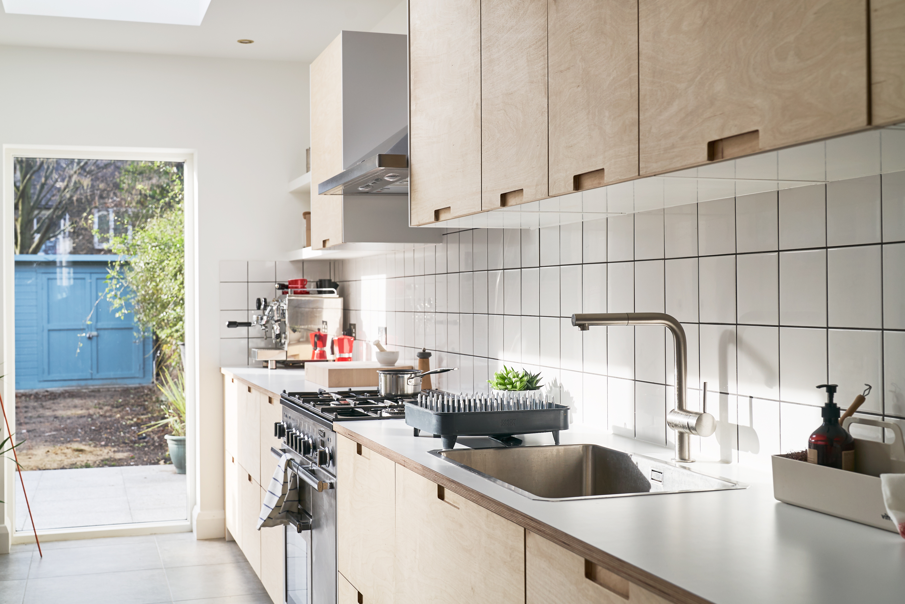 Birch plywood fronts, Formica countertops and semi-recessed grab handles