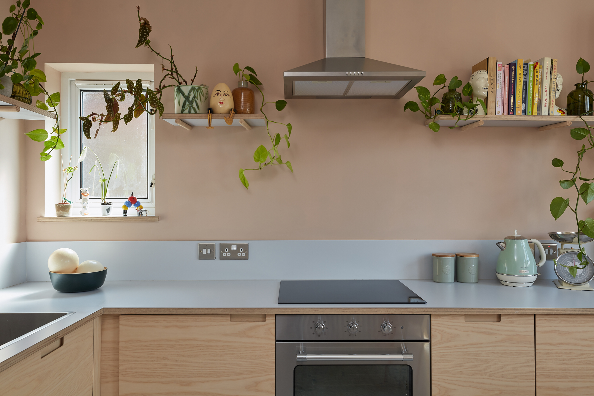 Plykea ash plywood fronts with semi-recessed handles and a Formica Glacier worktop and upstand