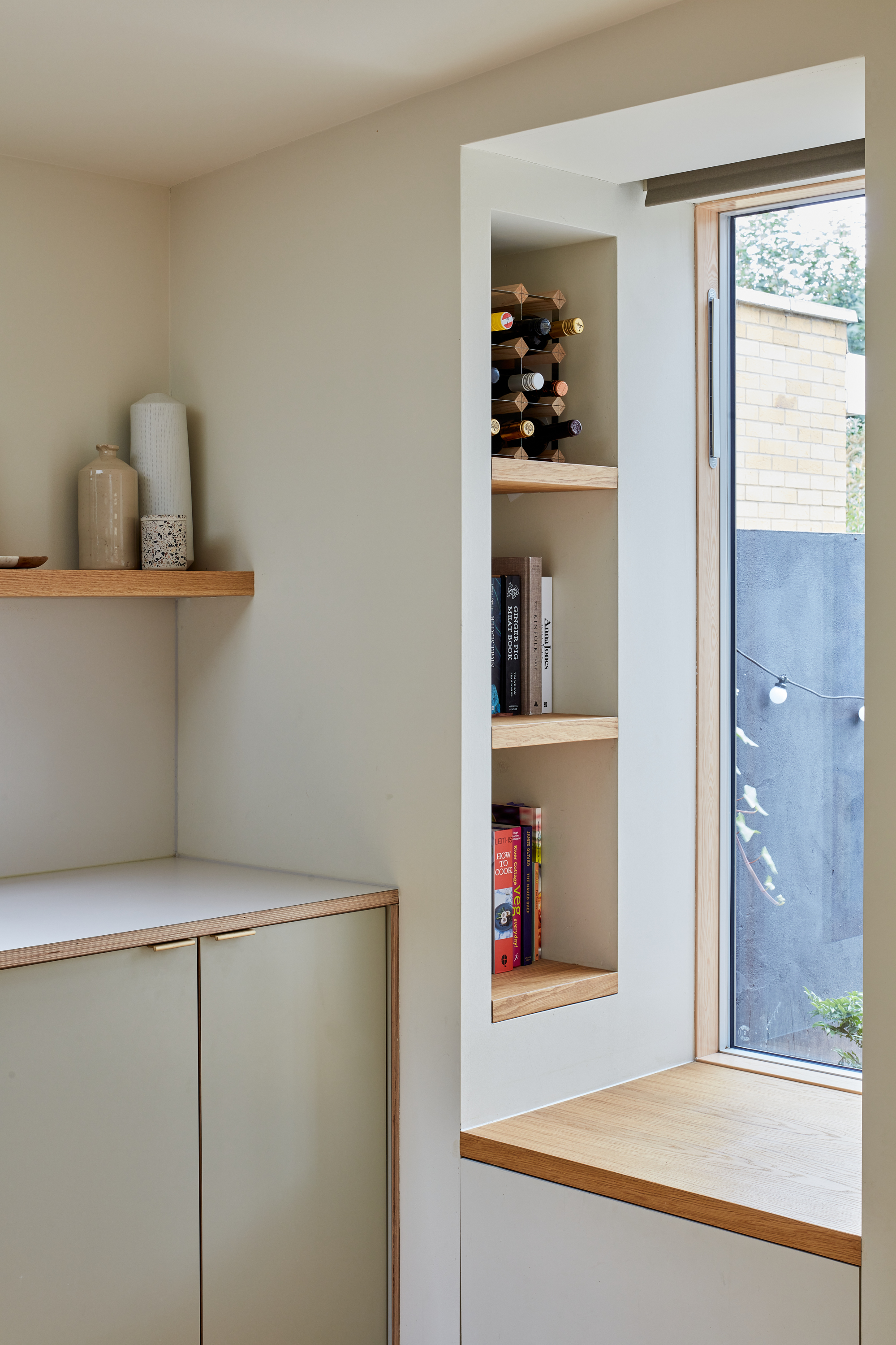 Plykea Formica Seed with brass edge pull handles and a Formica surf worktop
