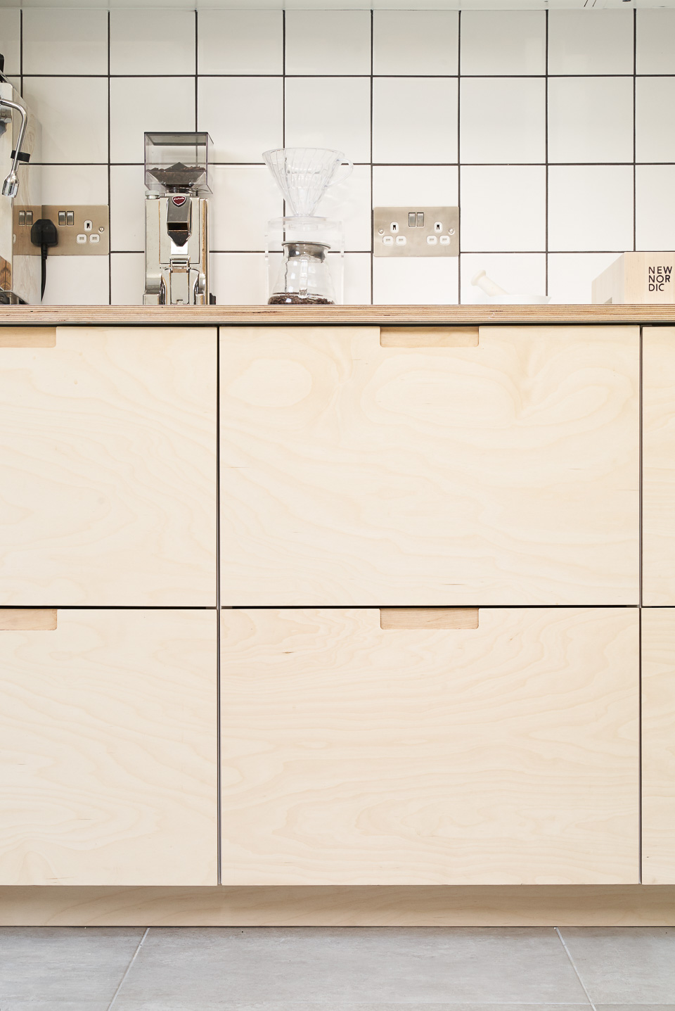 Birch plywood fronts, Formica countertops and semi-recessed grab handles