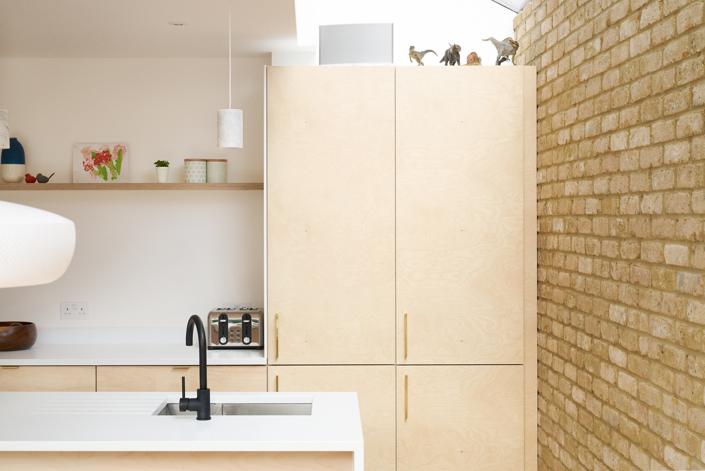 Birch plywood fronts and brass edge pulls handles in our Greville Road kitchen