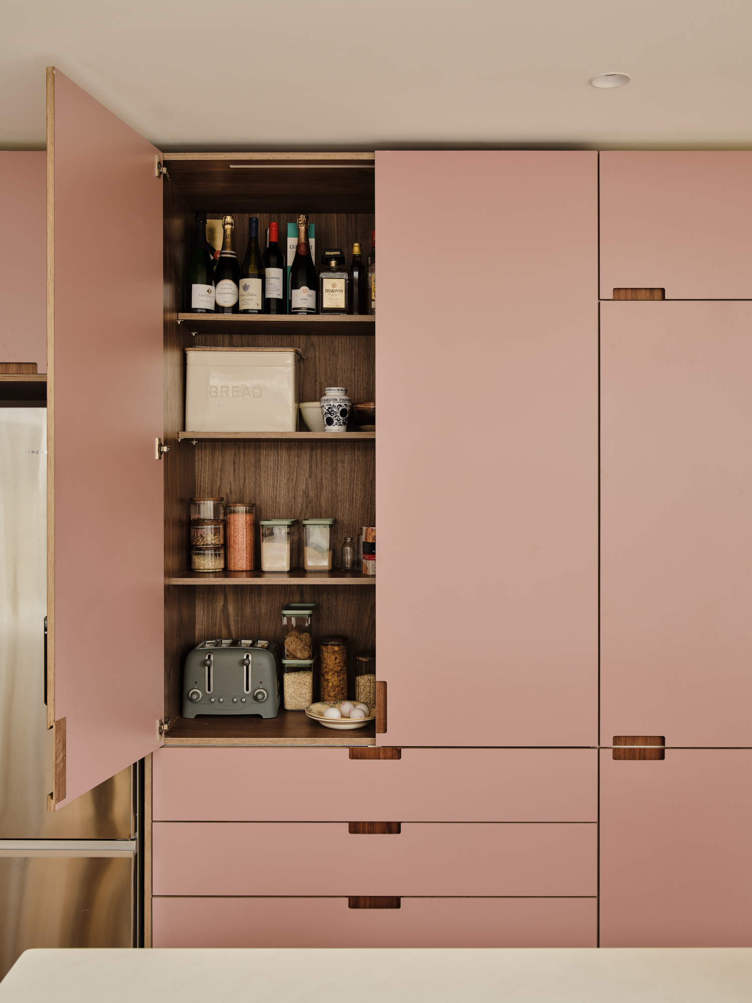 Plykea walnut pantry unit with Formica Blush doors sits neatly atop IKEA drawers
