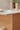 Plykea Formica Earthenware fronts and brass edge pull handles and a Fenix Bianco Male countertop