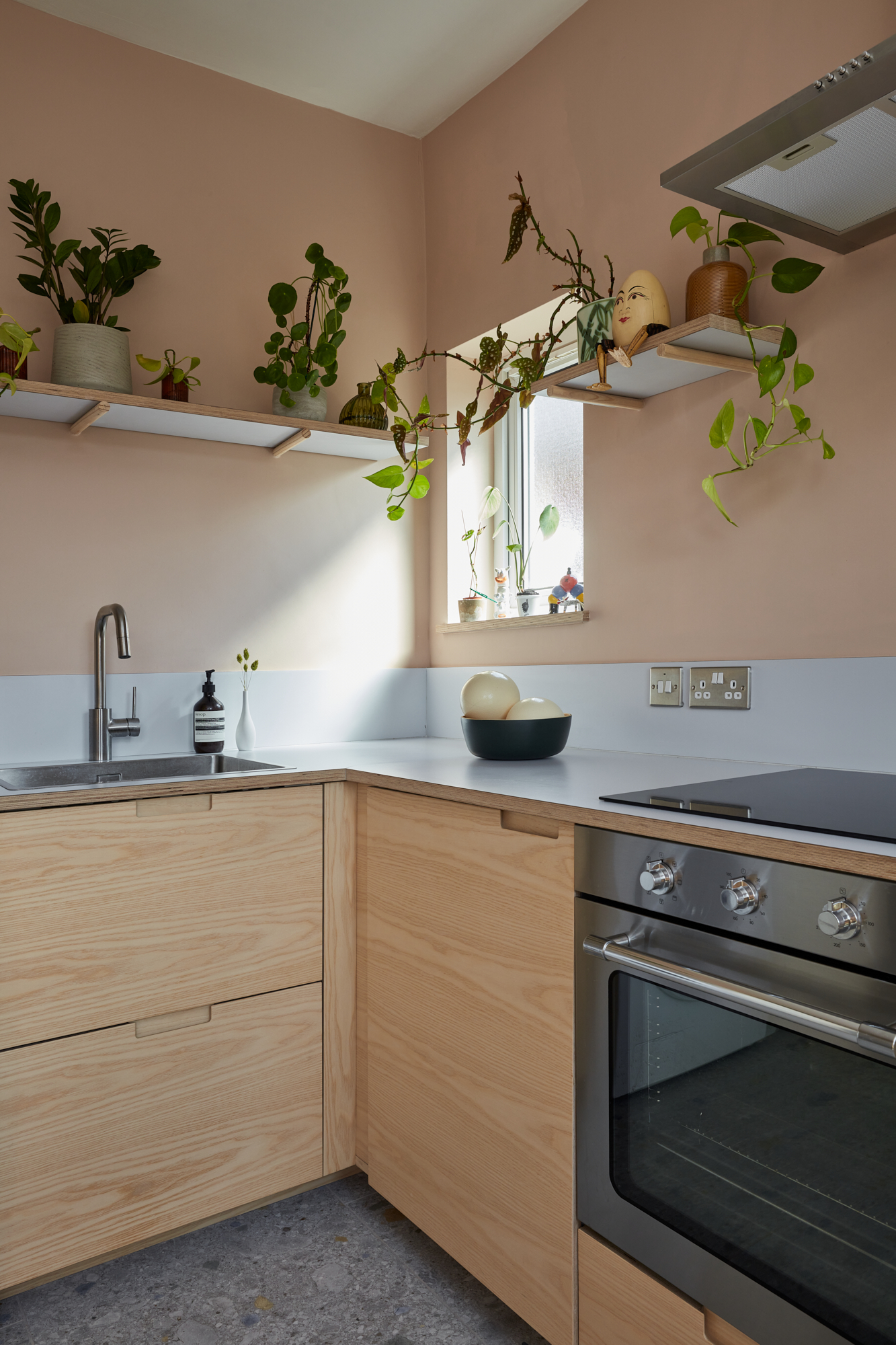 Plykea ash plywood fronts with semi-recessed handles and a Formica Glacier worktop and upstand