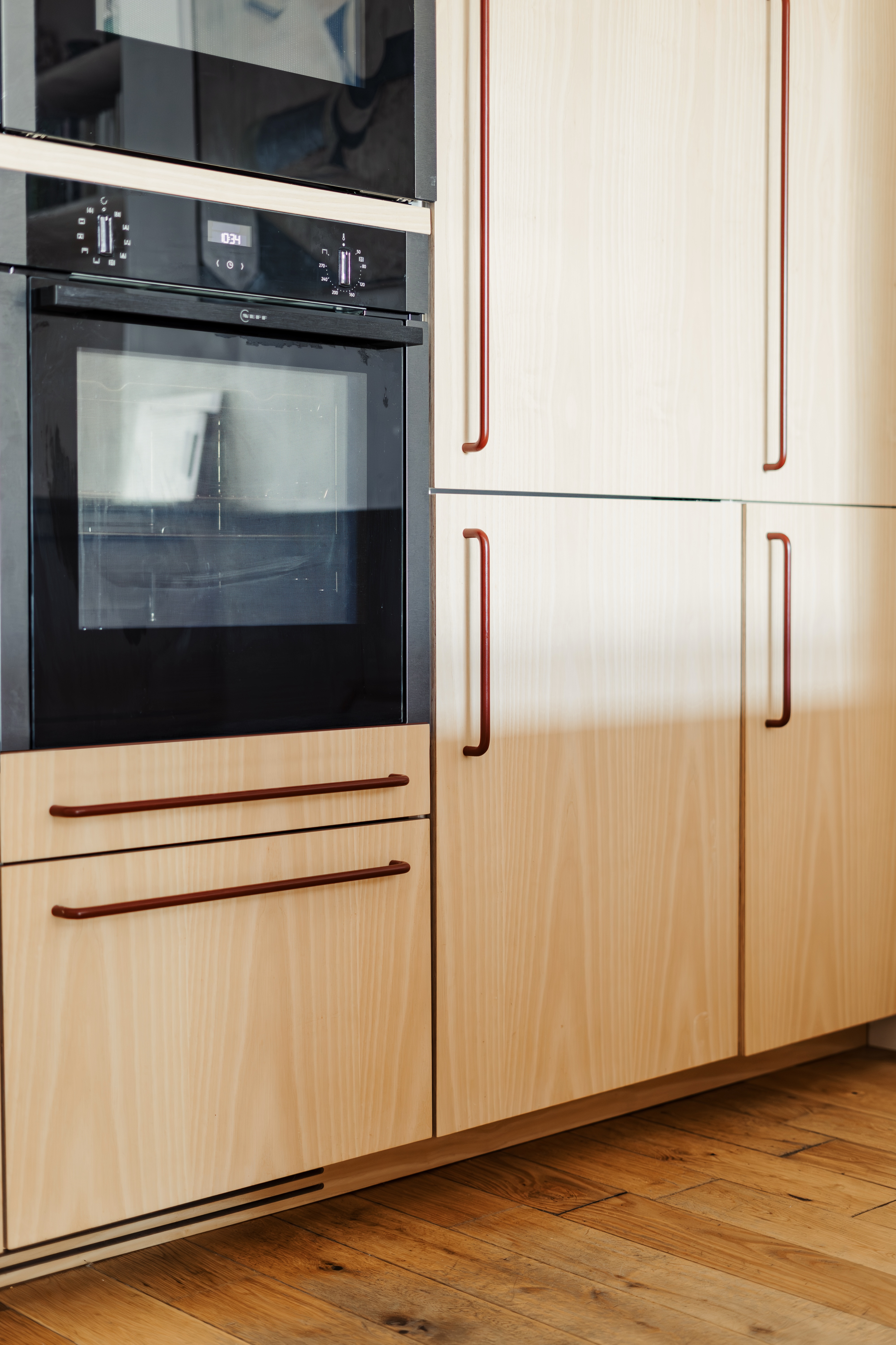 Plykea ash veneered birch plywood fronts with Swarf handles and Formica Tenere worktop