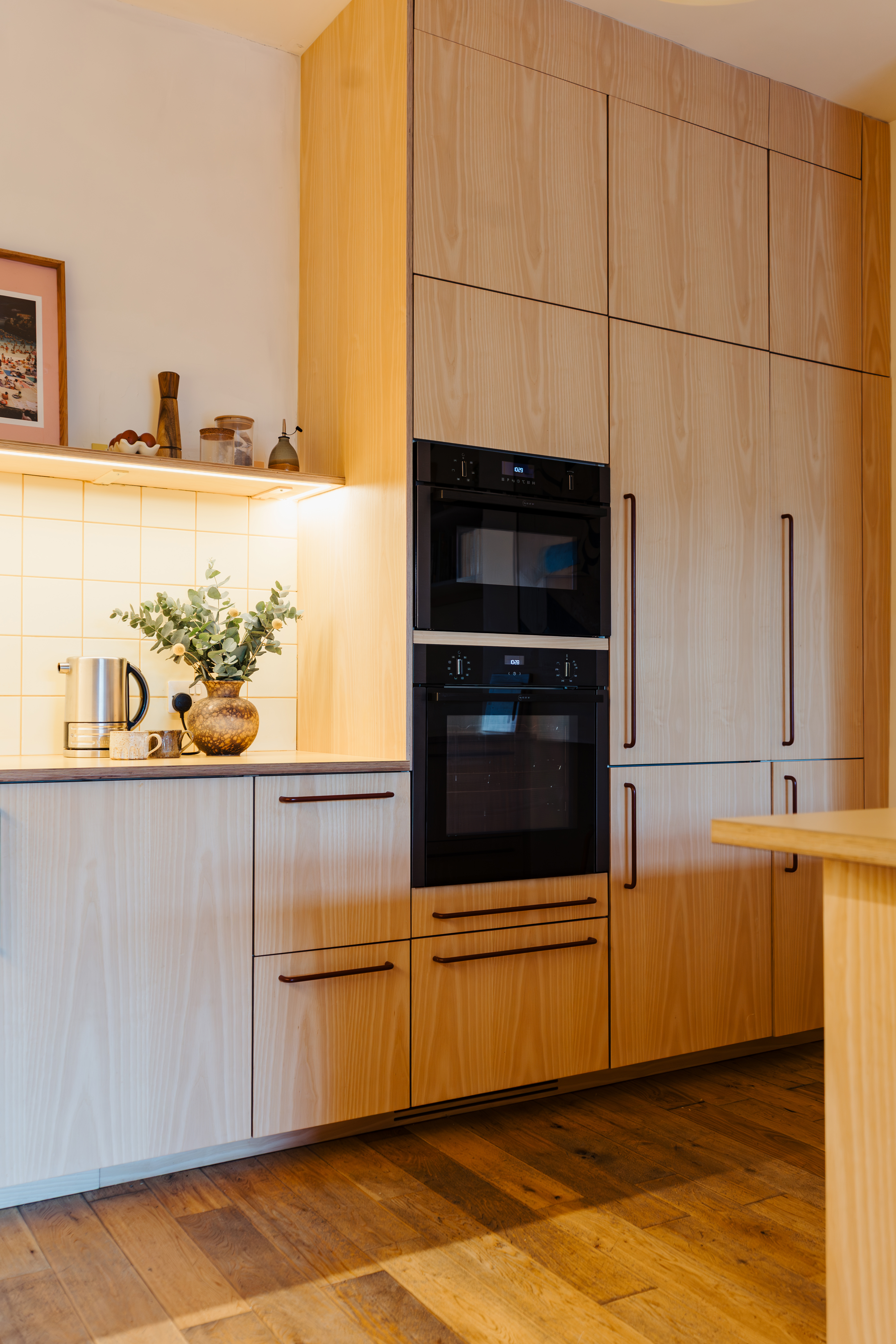 Plykea ash veneered birch plywood fronts with Swarf handles and Formica Tenere worktop