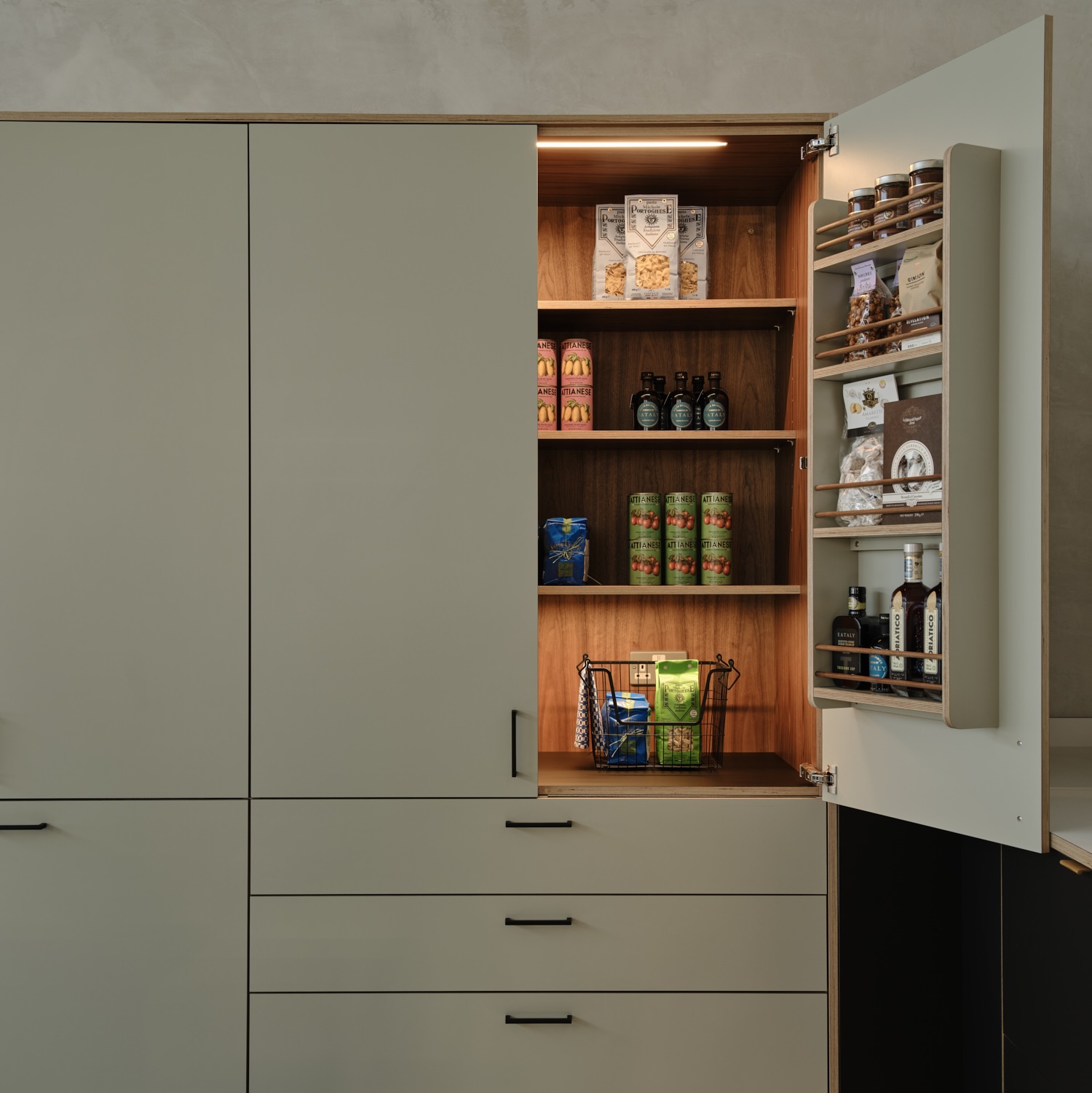 Double doored 1200mm walnut veneered birch plywood pantry unit with drawers beneath and Formica Seed fronts