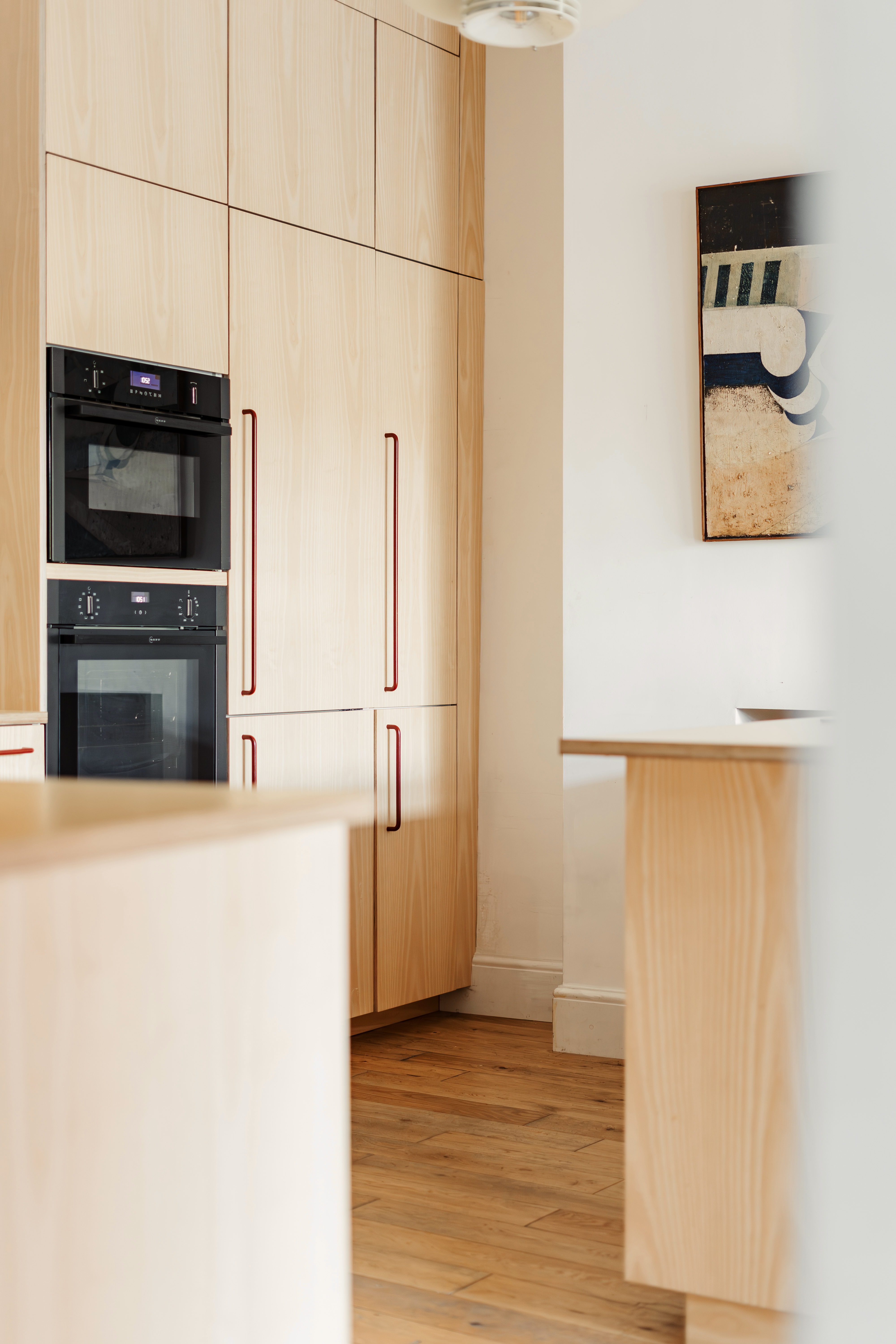 Plykea ash veneered birch plywood fronts with Swarf handles and yellow Formica Tenere worktop