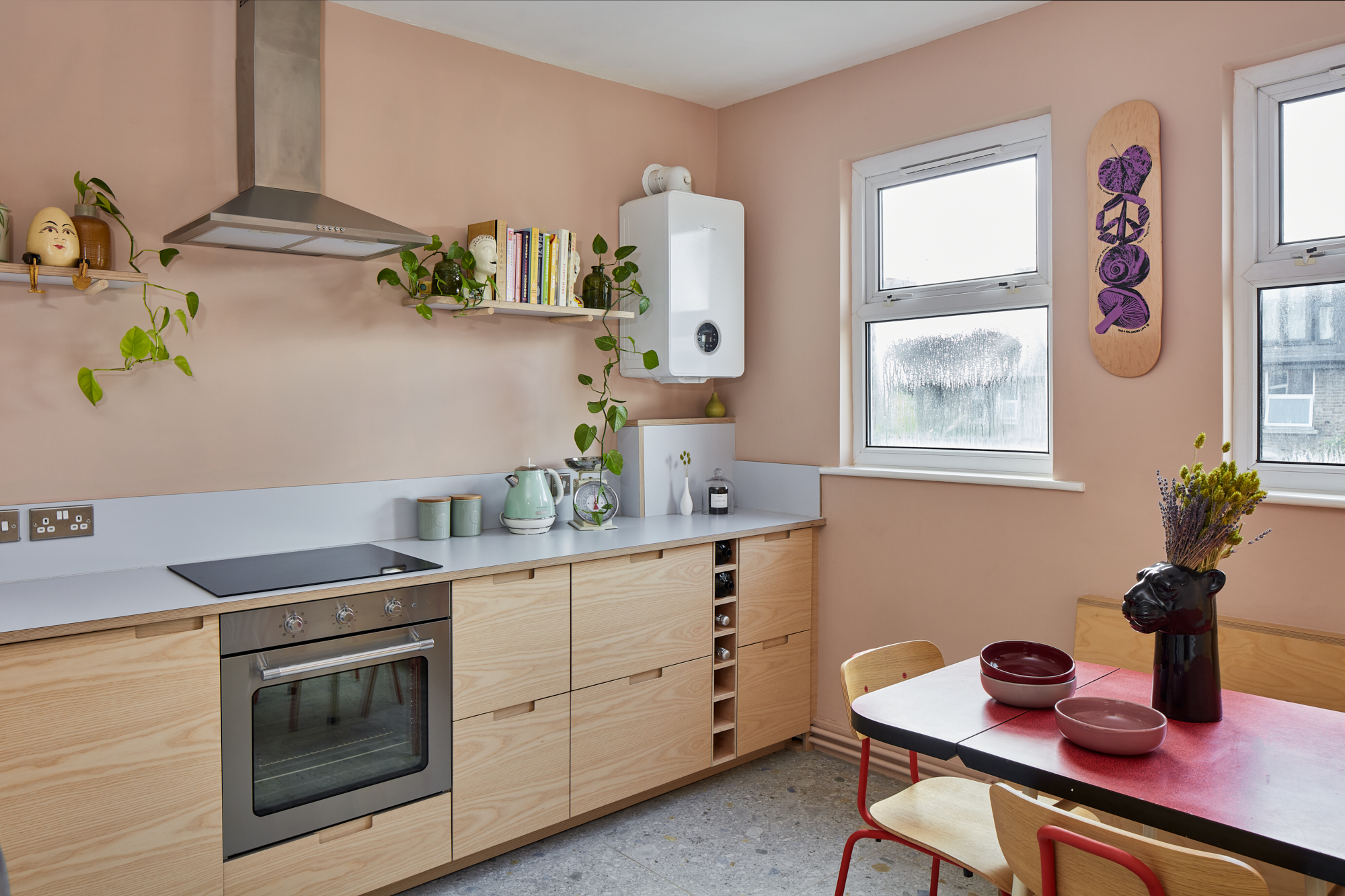 Plykea ash plywood fronts with semi-recessed handles and a Formica Glacier worktop and upstand