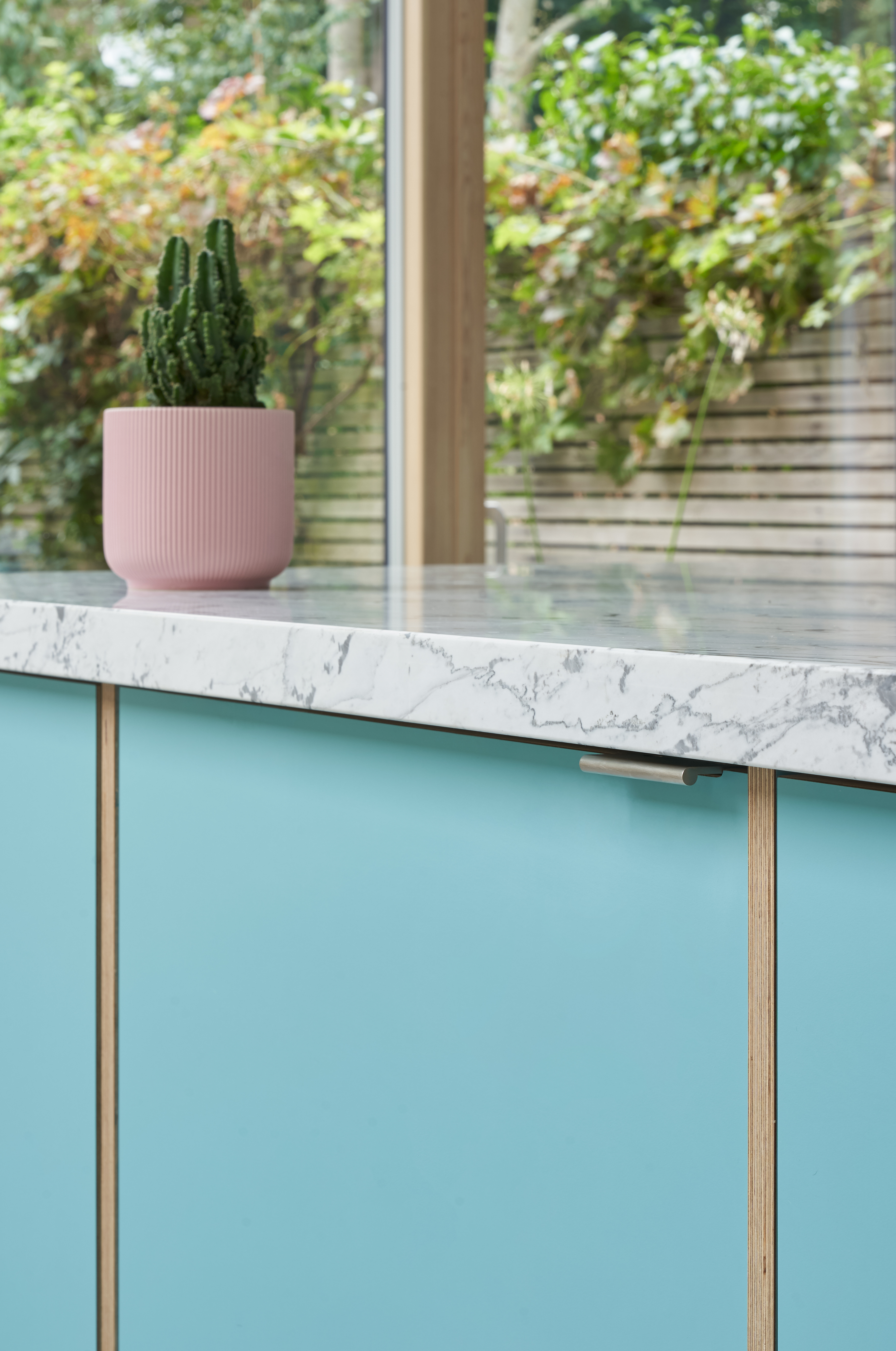 Plykea Formica Maui fronts with nickel edge pull handles and birch ply spacers on the island