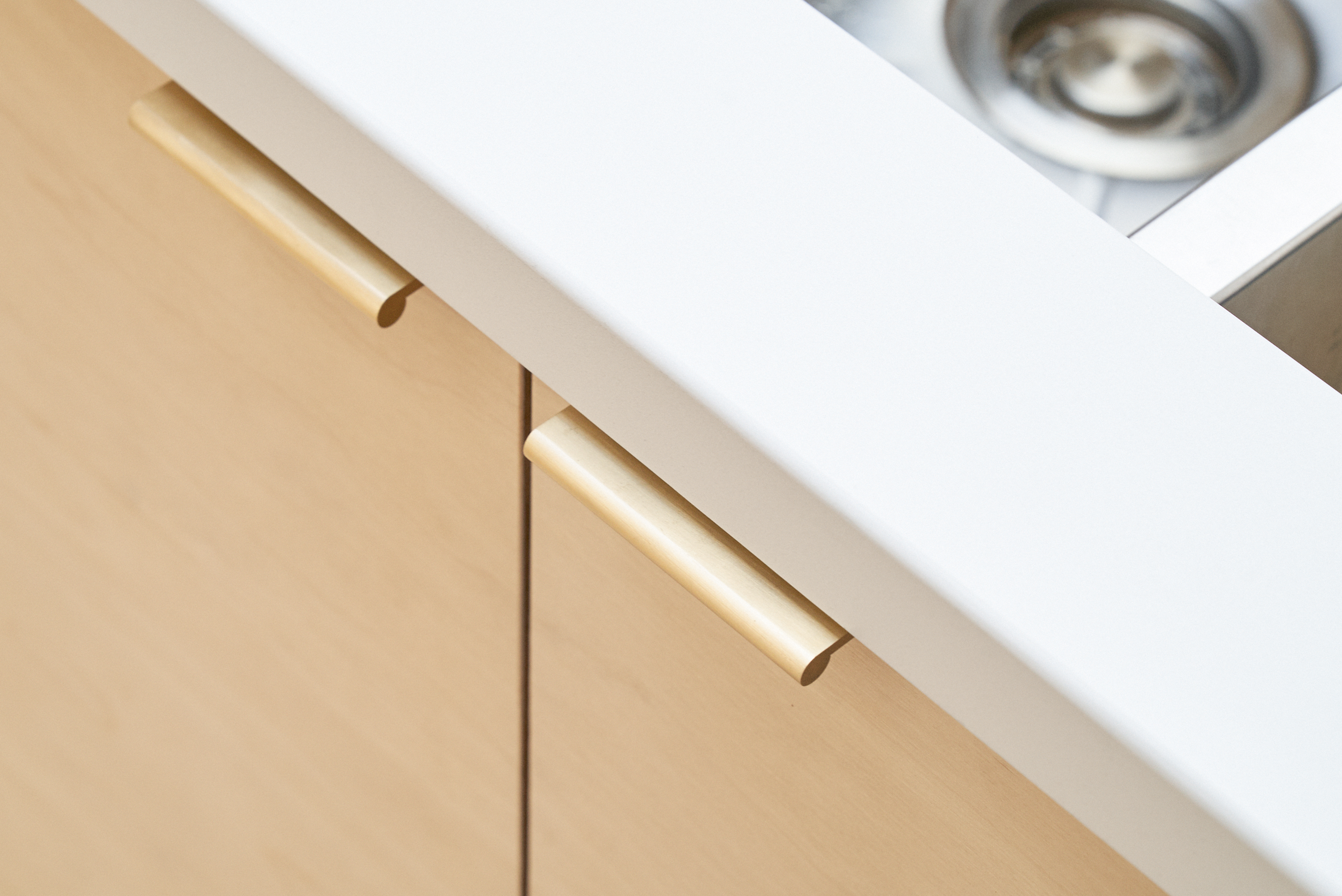 Birch plywood fronts and brass edge pulls handles in our Greville Road kitchen