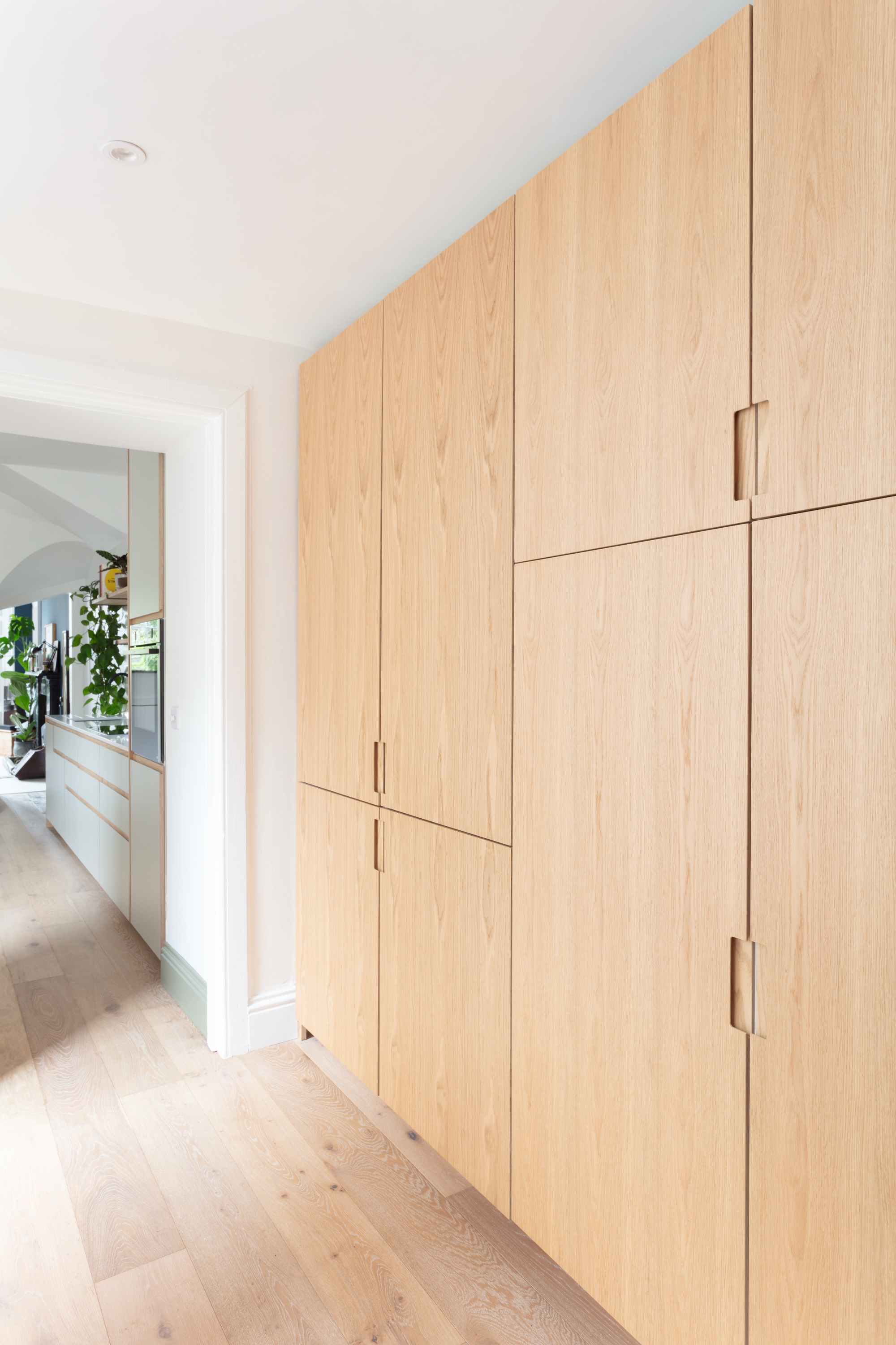 Plykea tall kitchen cabinets with a semi-recessed grab handle