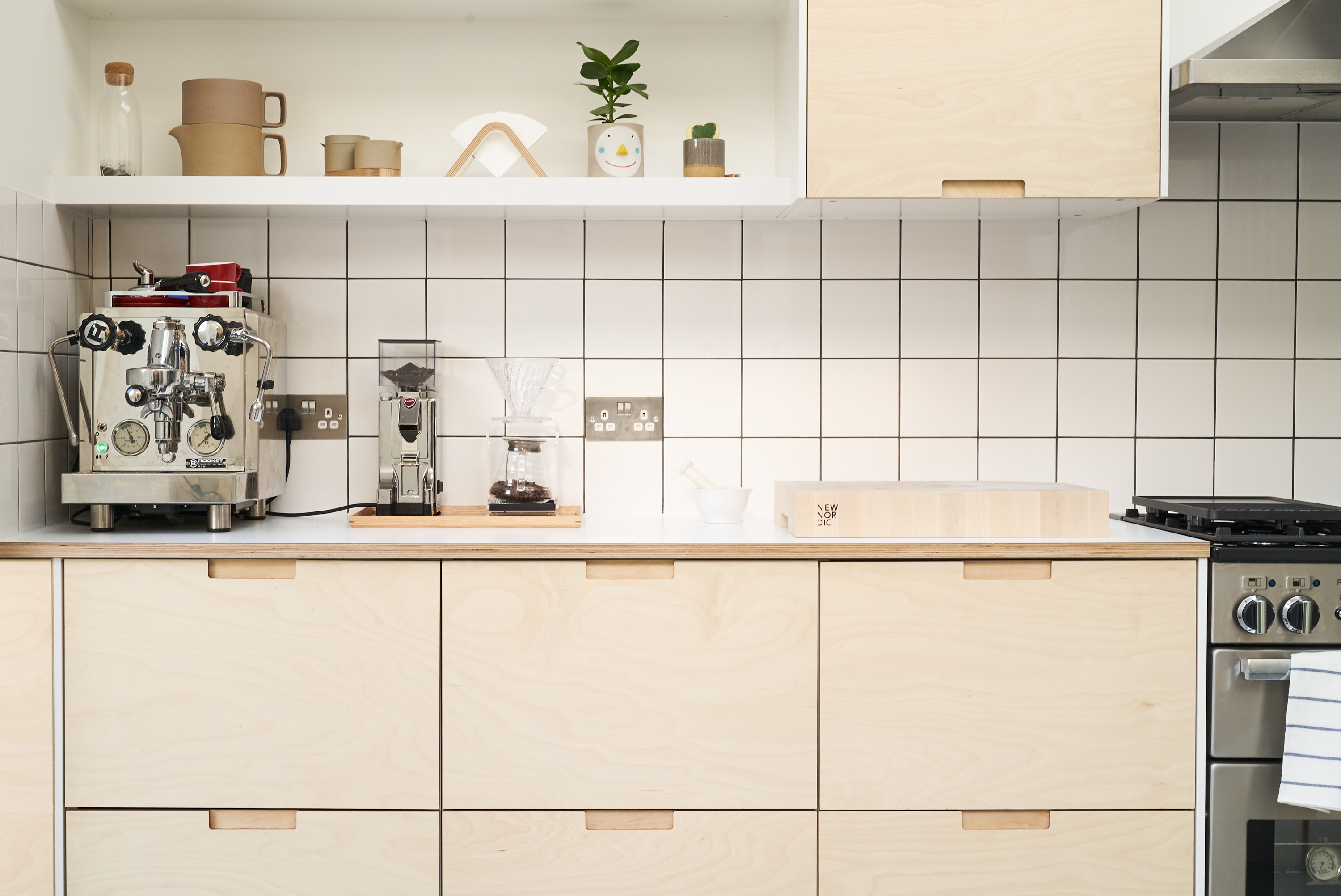 Birch plywood fronts, Formica countertops and semi-recessed grab handles